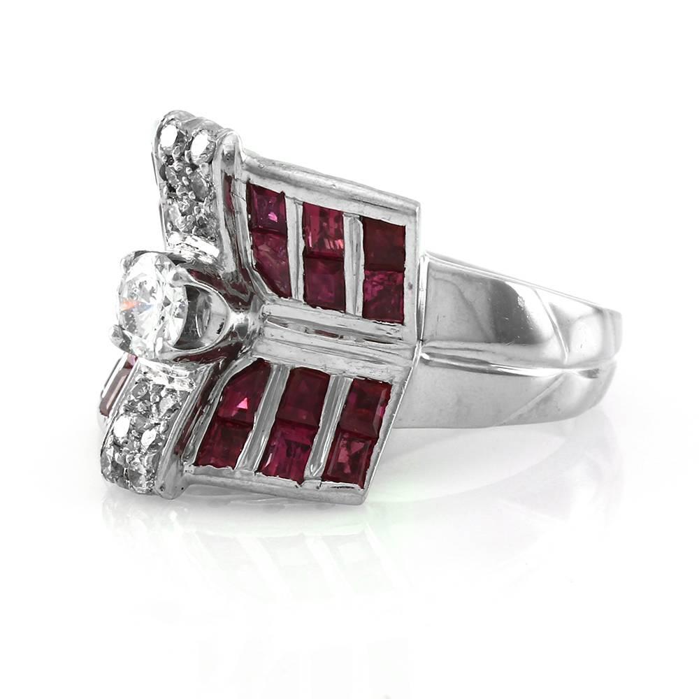 Vintage Art Deco ruby and diamond ring in high polished 14K white gold. 
There are one round brilliant cut diamond (0.48ct) with a color and clarity of H, I1, twelve round brilliant cut diamonds (0.24ctw) with a color and clarity of H-I, I2, and