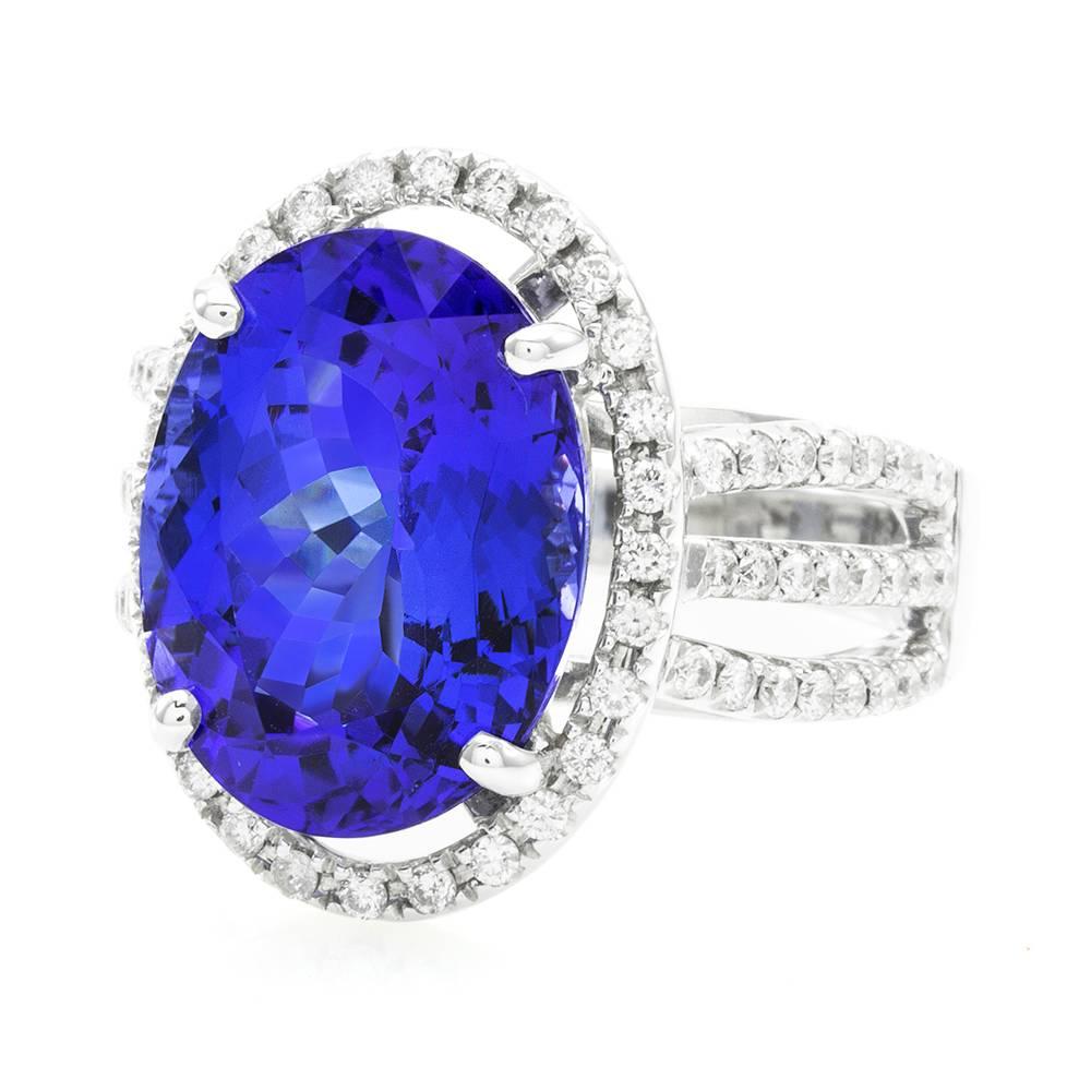 M. Christoff tanzanite and pavé diamond statement ring in high polished 14K white gold. There are one oval faceted cut tanzanite (7.15ct) and seventy-six round brilliant cut diamonds (0.56ctw). The diamonds have a color of H-I and a clarity of