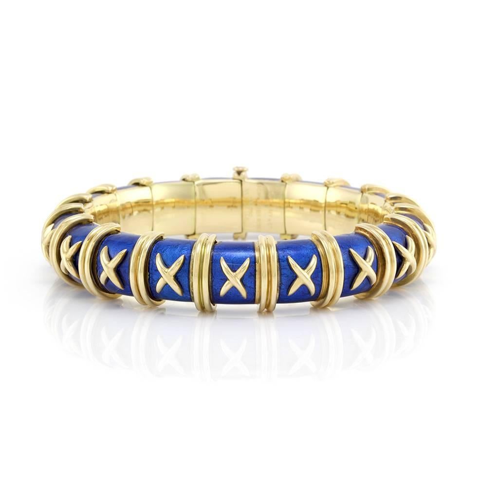 Vintage Jean Schlumberger for Tiffany and Co. Croisillon collection royal blue enamel bracelet in 18K yellow gold. The bracelet measures 12.8mm wide and is finished with a push button closure featuring a sliding safety lock. This bracelet has an