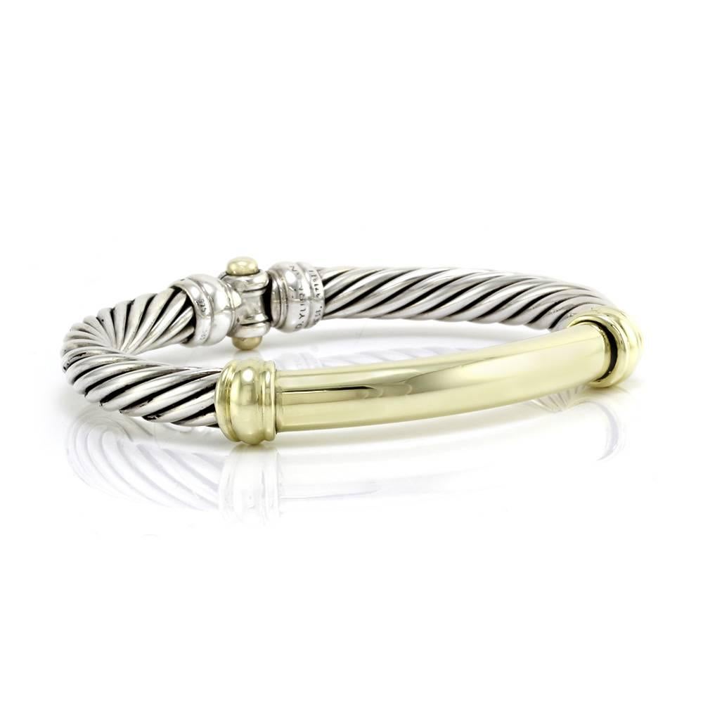 David Yurman Metro collection bracelet in sterling silver and 14K yellow gold. The bracelet is 9.5mm wide with an inner circumference of 6.5 inches. This bracelet is finished with a push button closure. The total weight for this item is 44.6g/