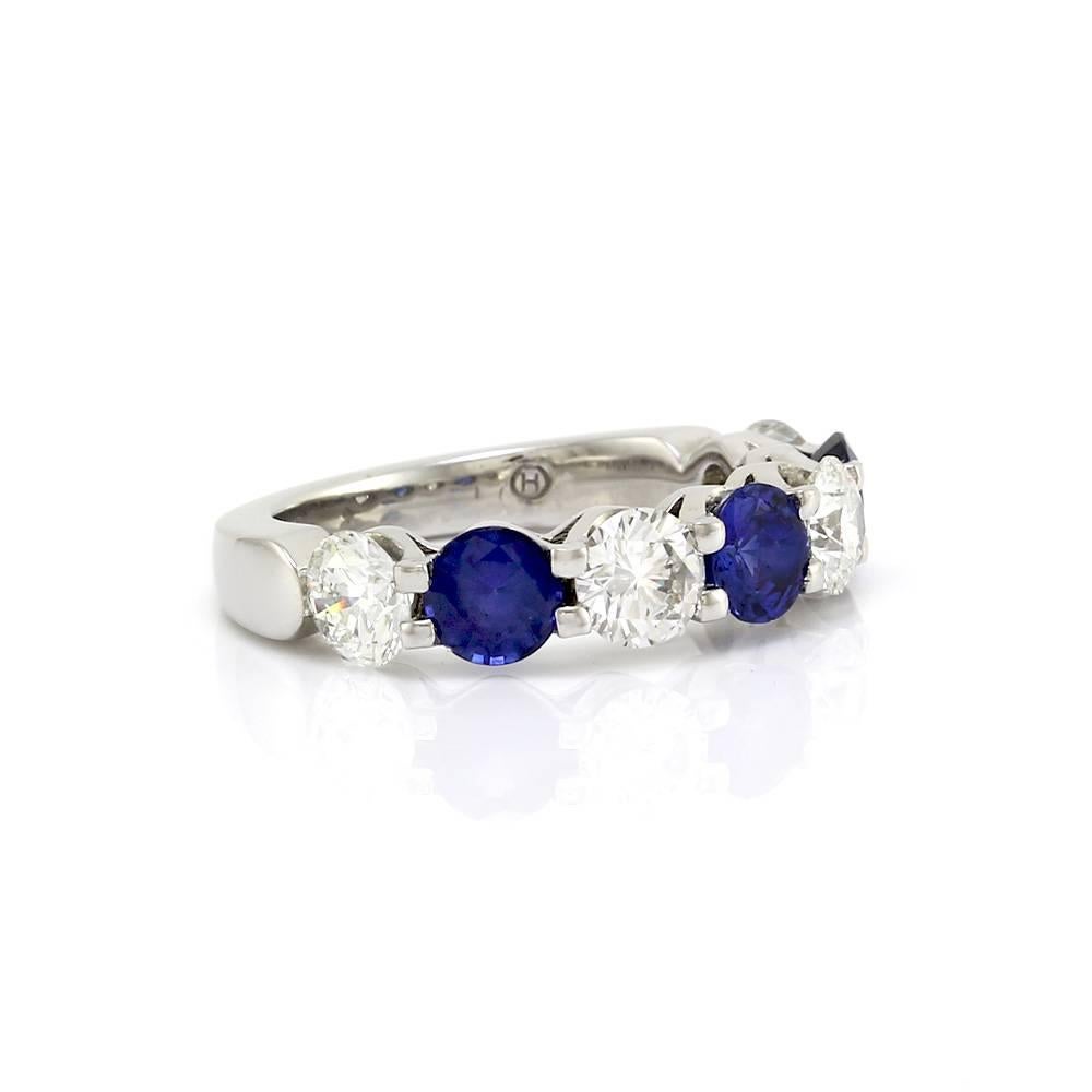 Alternating sapphire and diamond ring in high polished platinum. There are three round brilliant cut sapphires (1.74ctw) and four round brilliant cut diamonds (2.23ctw). The diamonds have a color of H-I and a clarity of VS2. All the gems are prong