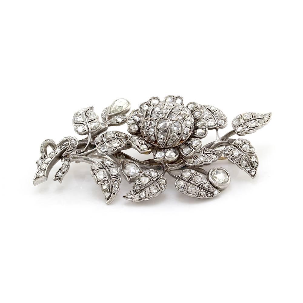 Antique tremble pin with floral motif in silver and 14K gold. There are one hundred twenty-seven rose cut diamonds (4.73ctw) with a color of H-I and a clarity of SI1-SI2. The two of the diamonds are bezel set and the remaining are bead set. The