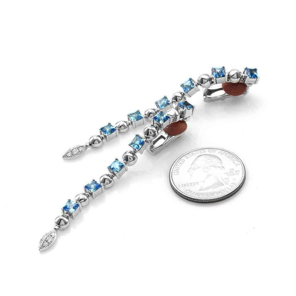Bvlgari (Bulgari) Lucea blue topaz and pavé diamond dangle earrings set in 18K white gold. There are twelve square faceted pavilion topaz with buff tops (12.45ctw) and twelve round brilliant cut diamonds (0.20ctw) with a color of G-H and a clarity