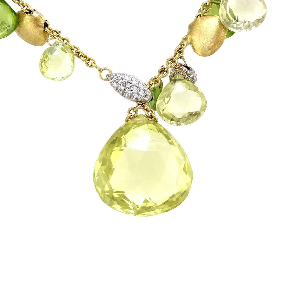 Marco Bicego prasiolite and peridot lariat necklace in 18K yellow gold. There are eight faceted prasiolite briolettes, six faceted peridot briolettes, and twenty-two textured gold beads. There are fifty-nine round brilliant cut diamonds (0.30ctw)