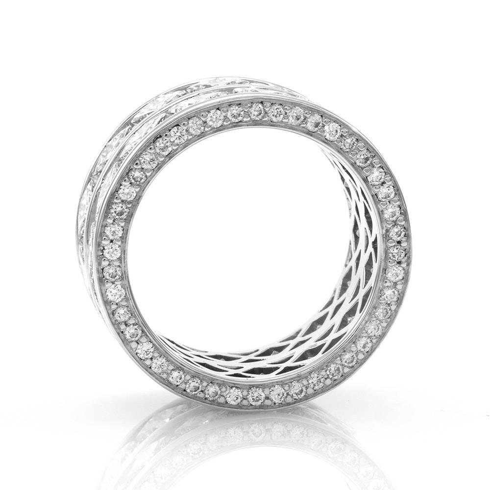 Diamond eternity ring/ cigar band in high polished 18K white gold and palladium. There are thirty princess cut diamonds (4.80ctw) and eighty-eight round brilliant cut diamonds (0.62ctw). The diamonds have a color of G-H and a clarity of VS1-VS2. The
