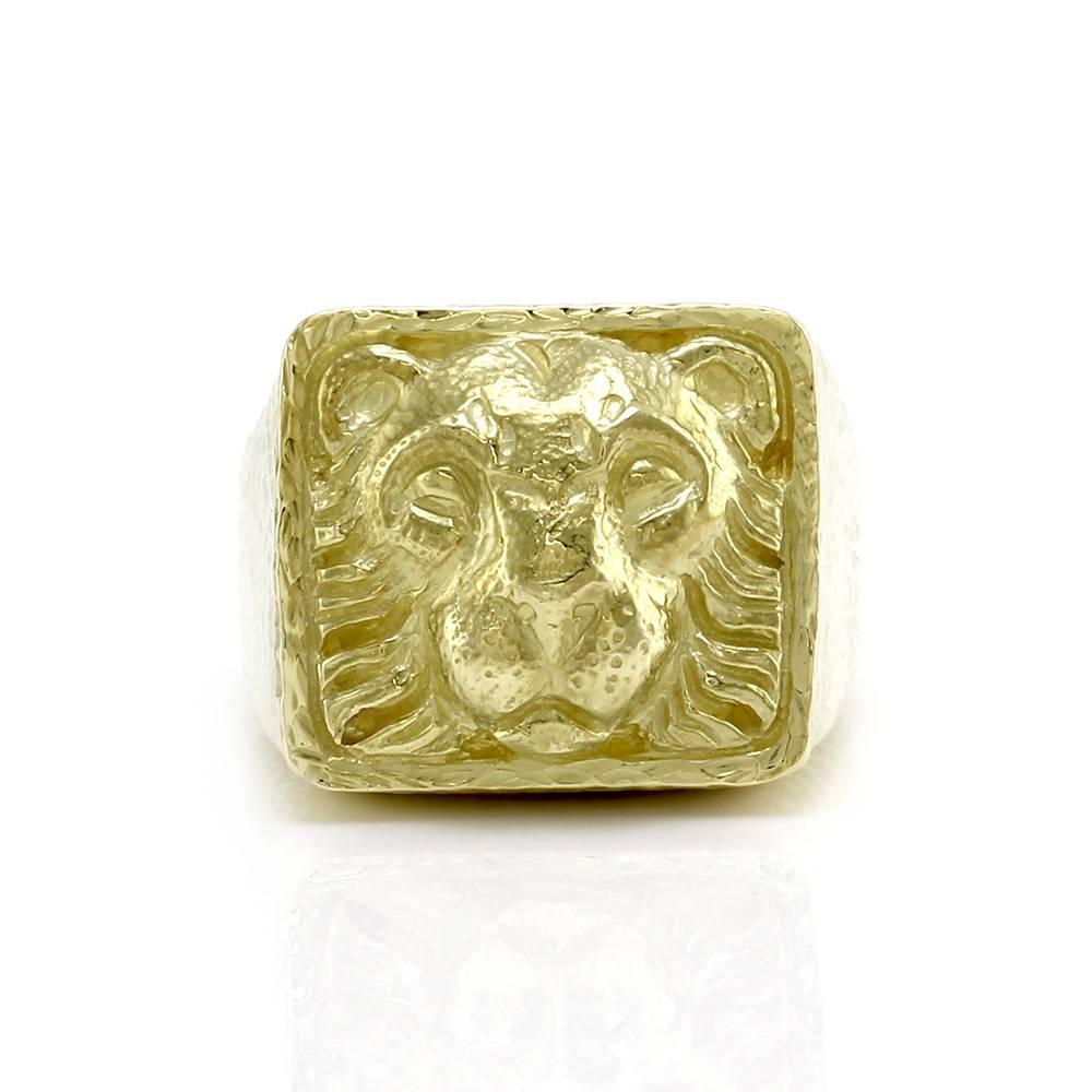 David Webb Ancient World collection lion ring in textured 18K yellow gold.  The overall size of this ring is (Head/ Embellishment) 18.7mm x 20.5mm, (Band Width) Graduated 4.9mm- 6.3mm, (Band Thickness) 1.3mm. The total weight of this ring is 25.4g/