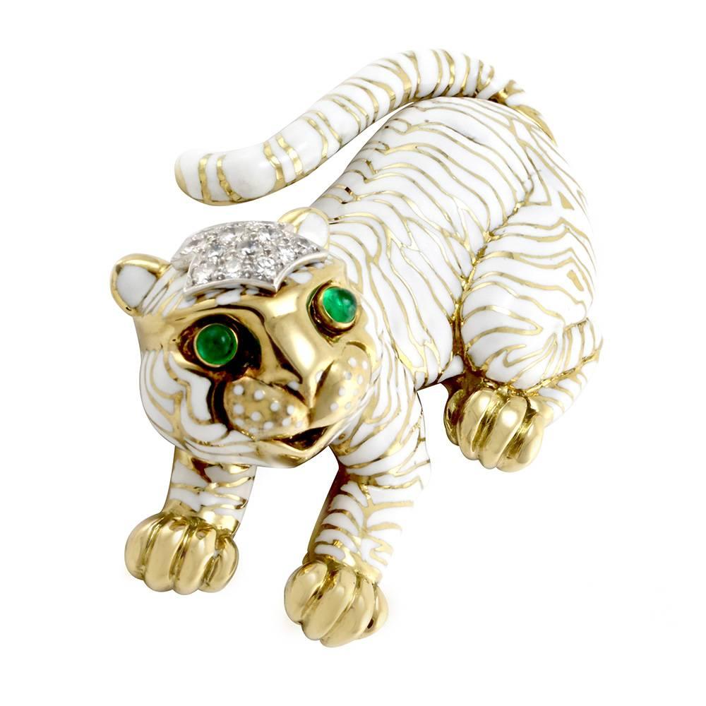 David Webb Kingdom collection white enamel tiger brooch/ pin with emeralds and diamonds  in 18K yellow gold/ platinum. There are two bezel set, round cabochon cut emeralds measuring 3.5mm each. There are fourteen bead set set, round brilliant cut