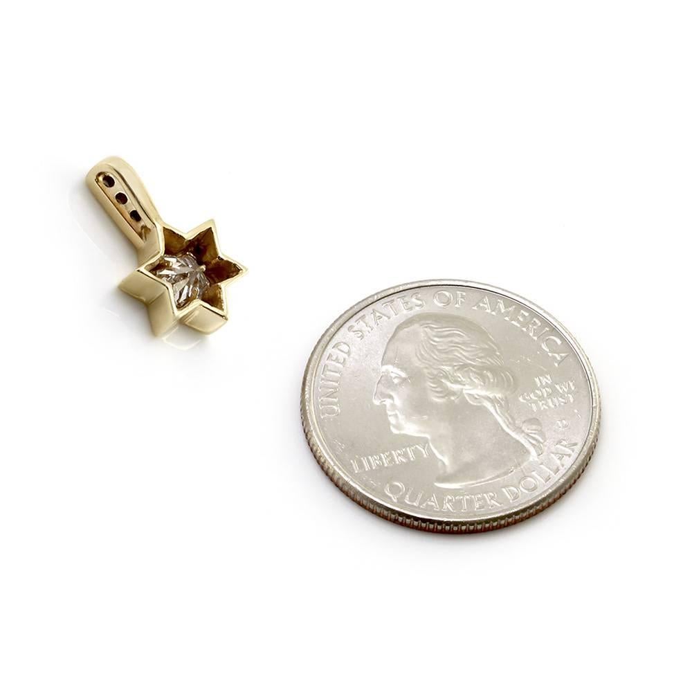 Star of David pendant w/ star cut diamond in 14K yellow gold. There are one star cut diamond (0.59ctw), one round brilliant cut diamond (0.01ctw), and two single cut diamonds (0.02ctw). The center star cut diamond has a color of G and a clarity of