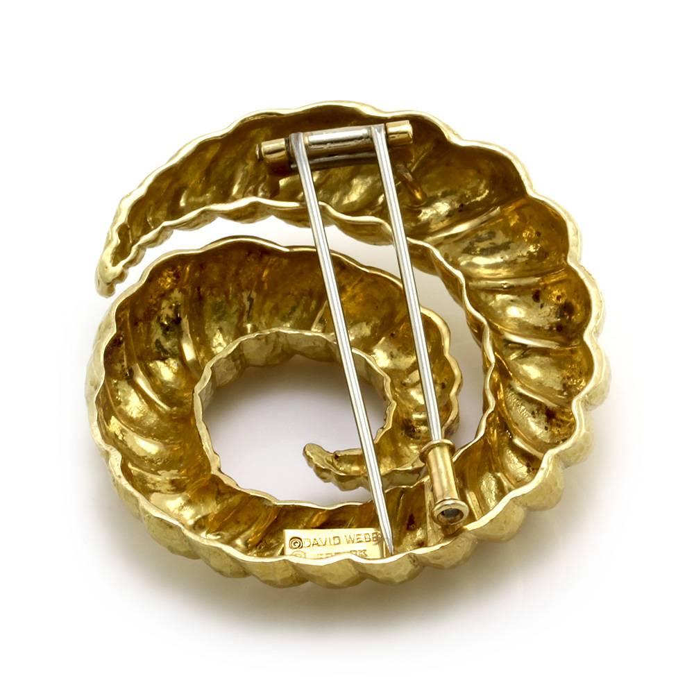 David Webb spiral pin in hammered finished 18K yellow gold. The pin measures 48.1mm x 44.9mm. The total weight for this item is 40.0g/ 25.8dwt.

Hallmark/Maker's Mark: ©DAVID WEBB ®WEBB 18K

Retail Appraisal Value: $7,800.00
