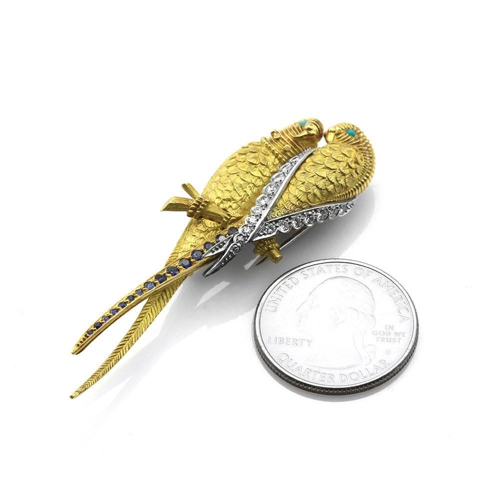 Van Cleef & Arpels parrot pin with multi-gems in highly detailed 18K yellow gold and platinum. There are fifteen round faceted cut sapphires (0.23ctw), two round cabochon cut turquoise (1.5mm), five round single cut diamonds and thirteen round
