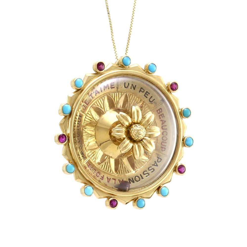 Van Cleef & Arpels Game of Chance spinning roulette wheel pendant set in 18K yellow gold. There are five round faceted rubies (0.20ctw) and ten round turquoise cabochons (2.2mm) that are bezel set on the outer ring of the wheel. This pendant is