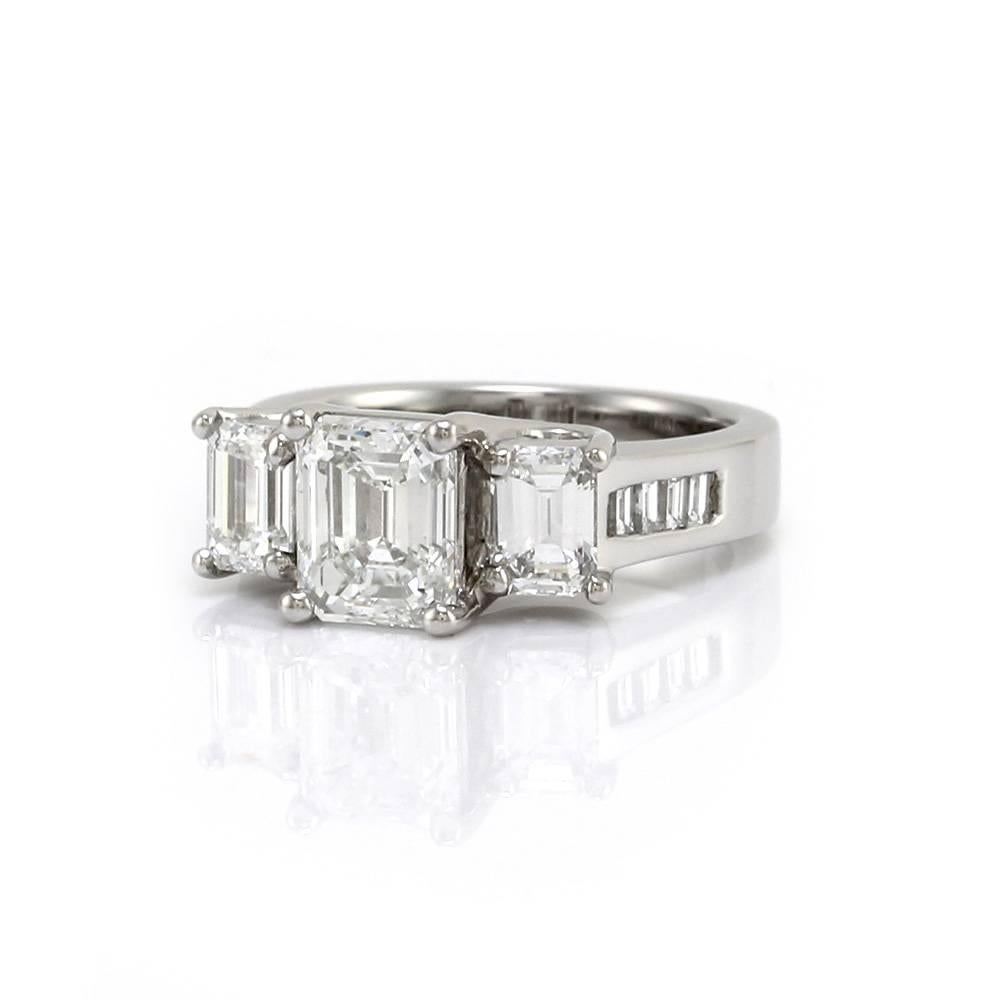 Emerald cut diamond engagement ring with baguette cut diamond accents set in 900 platinum. There is one G.I.A. emerald cut diamond (1.51ct) with a color of F and a clarity of SI1. There are eight baguette cut diamonds (0.24ctw) with a color of G-H
