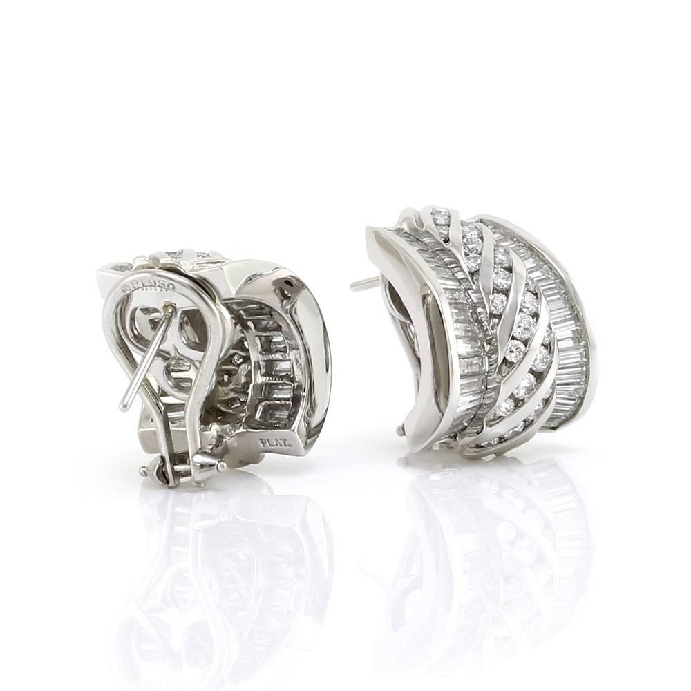 Charles Krypell diamond semi-hoop omega back earrings set in platinum. There are one hundred twenty-four round brilliant and baguette cut diamonds total (8.00ctw) with a color of F-G and a clarity of VVS-VS. The round diamonds are set in twisted