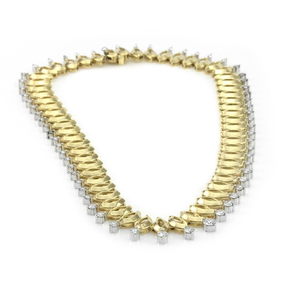 Marquise shaped link diamond drop necklace set in 18K yellow gold and platinum. There are sixty-one round brilliant cut diamonds (7.59ctw) with a color of G-H and a clarity of VVS-VS. The flexible links are made of high polish yellow gold, with