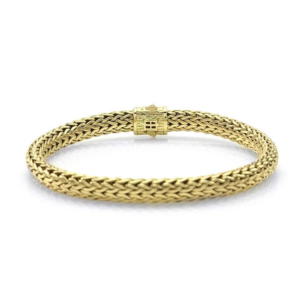 John Hardy Classic Wheat pavé diamond bracelet set in 18K yellow and white gold. There are thirty-two round brilliant cut diamonds (0.16ctw) with a color of G-H and a clarity of VS-SI. The diamonds are bead set in white gold on the clasp. The