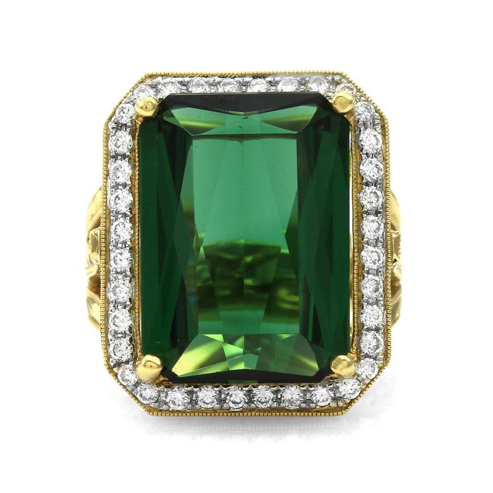 Green tourmaline and pavé diamond ring set in 18K gold. There are one fancy emerald cut tourmaline (14.94ct) and thirty-six round brilliant cut diamonds (0.54ctw) with a color of G-H and a clarity of VS. The tourmaline is prong set in yellow gold,