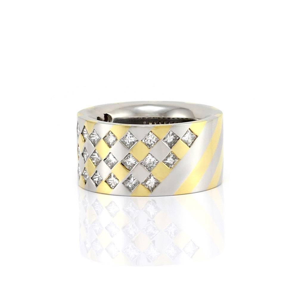 Princess cut diamond band ring in platinum and 22K yellow gold. There are thirty-three princess cut diamonds (2.97ctw) with a color of H-L and a clarity of SI. The diamonds are flush set in alternating channels of high polish candy stripe platinum