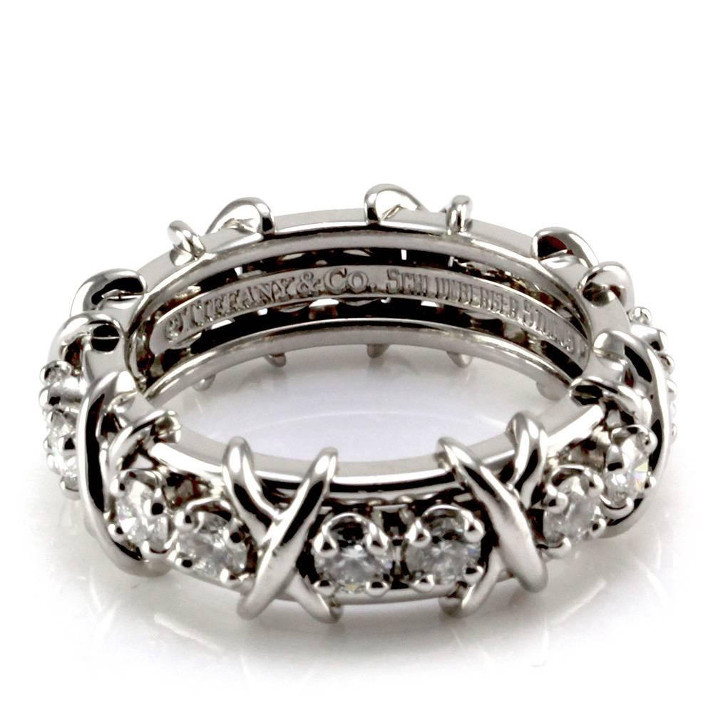 Tiffany & Co. Schlumberger sixteen stone diamond ring set in platinum. There are sixteen round brilliant cut diamonds (1.14ctw) with a color of F-H and a clarity of VS1-VS2. The diamonds are prong set between x shaped platinum embellishments, which