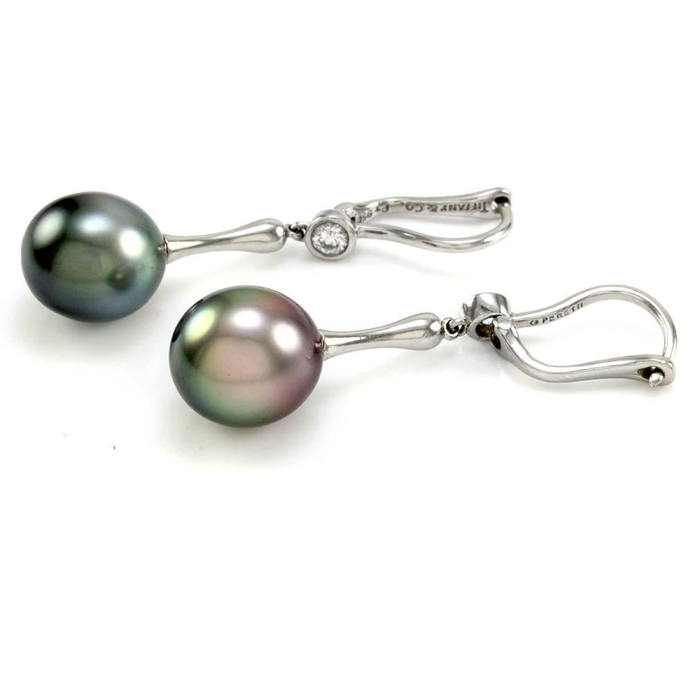 Tiffany & Co. Elsa Peretti Tahitian pearl earrings with diamonds in platinum. There are two Tahitian drop pearls (11.5mm) and two round brilliant cut diamonds (0.25ctw) with a color of H and a clarity of VS1. The pearls are custom set, and the
