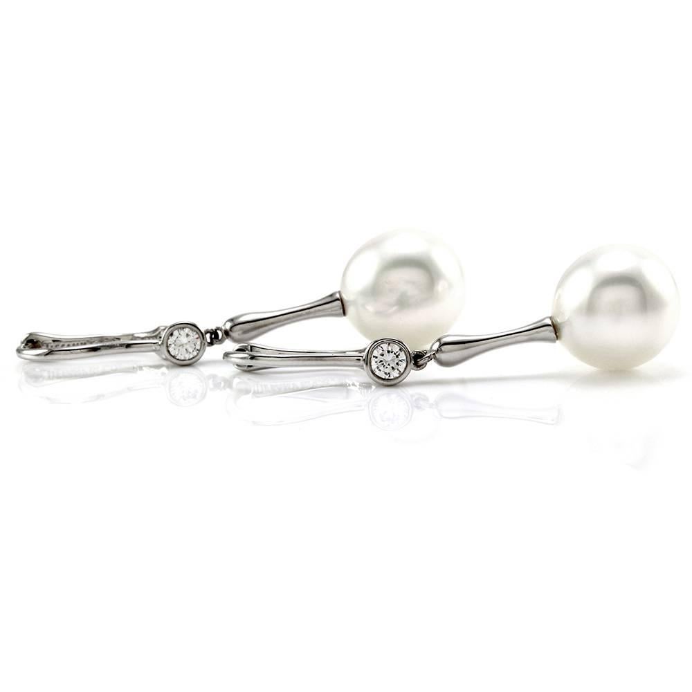 Tiffany & Co. Elsa Peretti South Sea pearl earrings with diamonds in platinum. There are two South Sea drop pearls  11.5mm) and two round brilliant cut diamonds (0.25ctw) with a color of H and a clarity of VS1. The pearls are custom set, and the