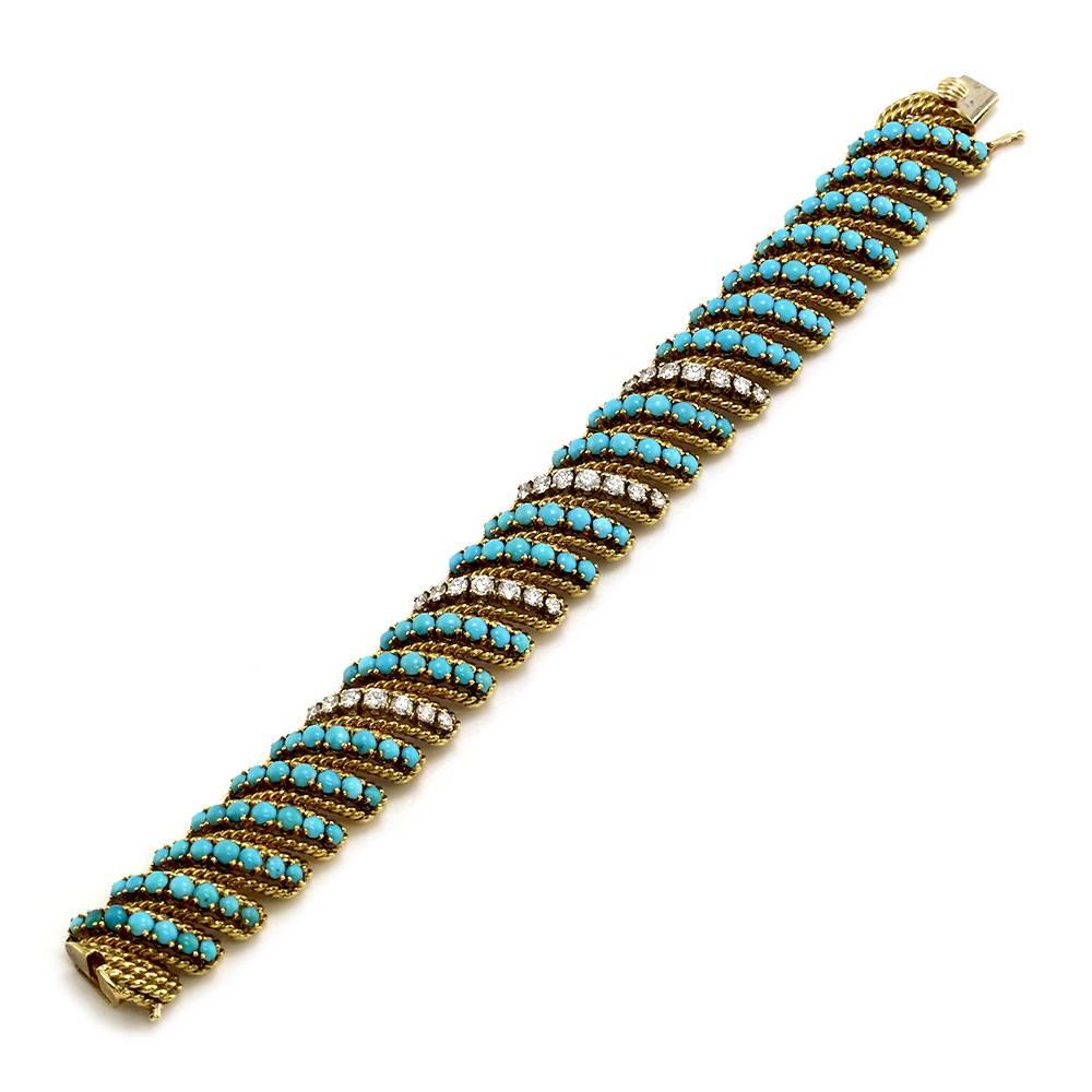 Turquoise and diamond articulating wide bracelet in 18KL yellow gold. There are one hundred thirty-three round turquoise cabochons (2.5mm-3.5mm) and twenty-eight round brilliant cut diamonds (2.64ctw) with a color of F-G and a clarity of VS. All