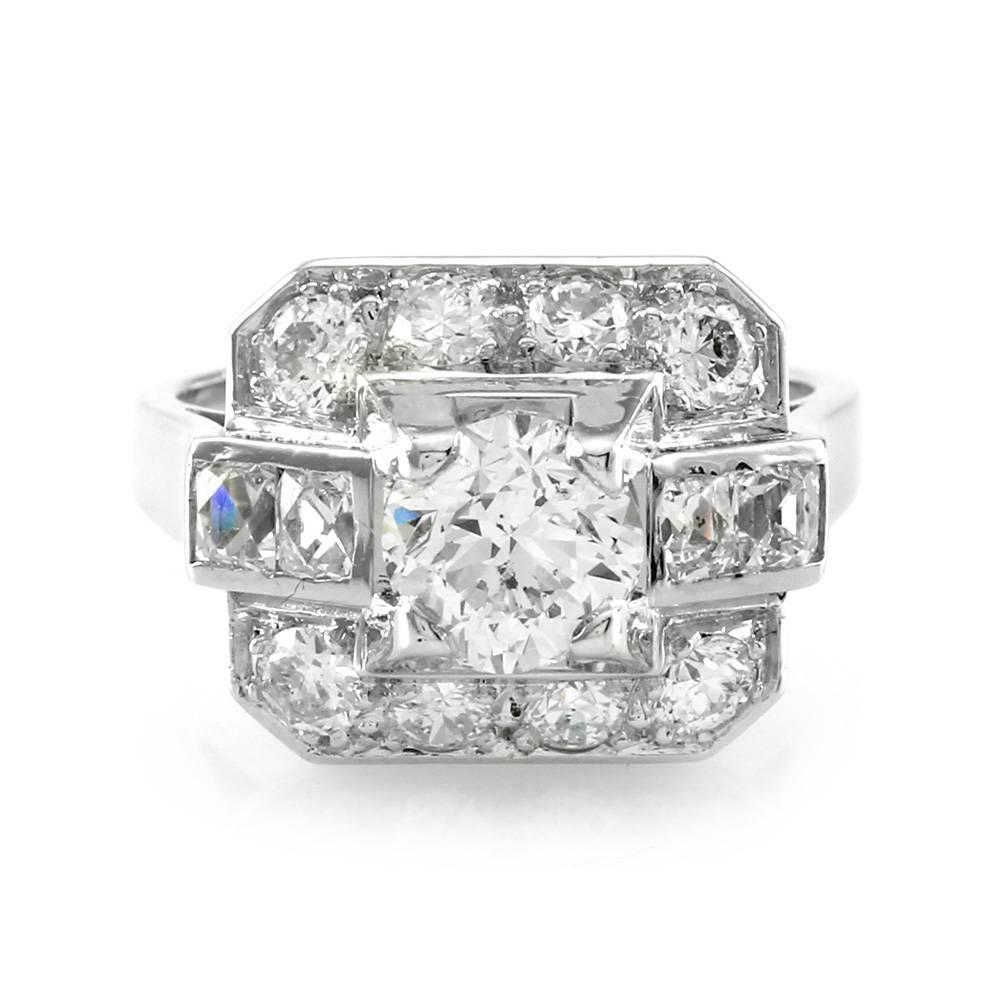 Vintage Art Deco diamond ring in 18K white gold. There is one round brilliant cut diamond (1.53ct) with a color of J and a clarity of I1. There are eight transition cut diamonds (1.00ctw) and four french cut diamonds (0.50ctw) with a color of G-I