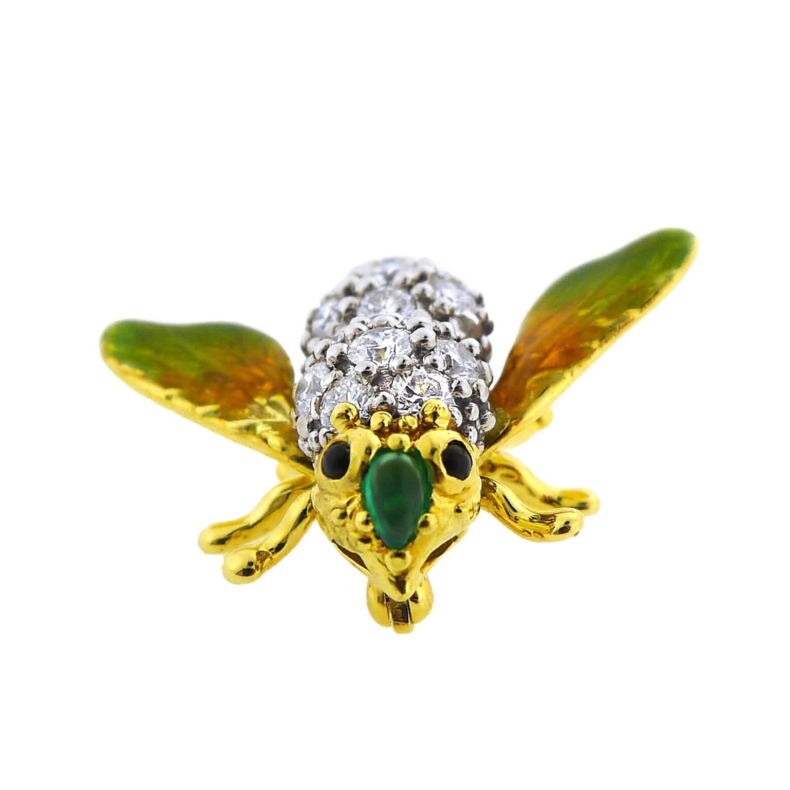 18 karat yellow and white gold bee pin with black onyx eyes and a cabochon emerald nose.  20 round brilliant cut diamonds total 1.15 carats and are F color and VS clarity.  Pin measures 1 1/8 inches across by 1 inch tall.  Original T. Foster &