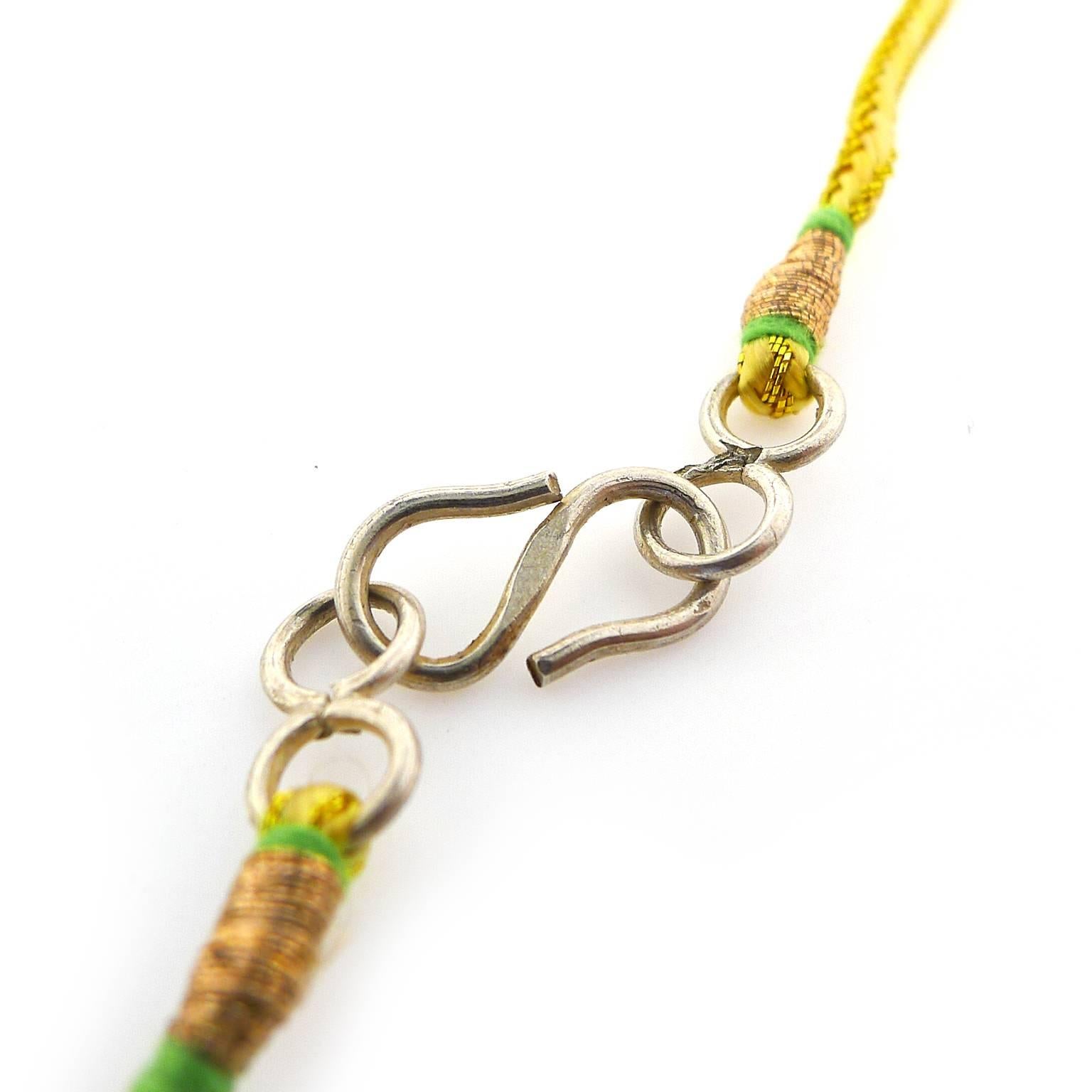 Necklace measures 18 inches with a silver colored clasp strung onto gold colored cording. 19 peridot briolettes can be worn as is or redesigned into an amazing piece of jewelry with your local jeweler.