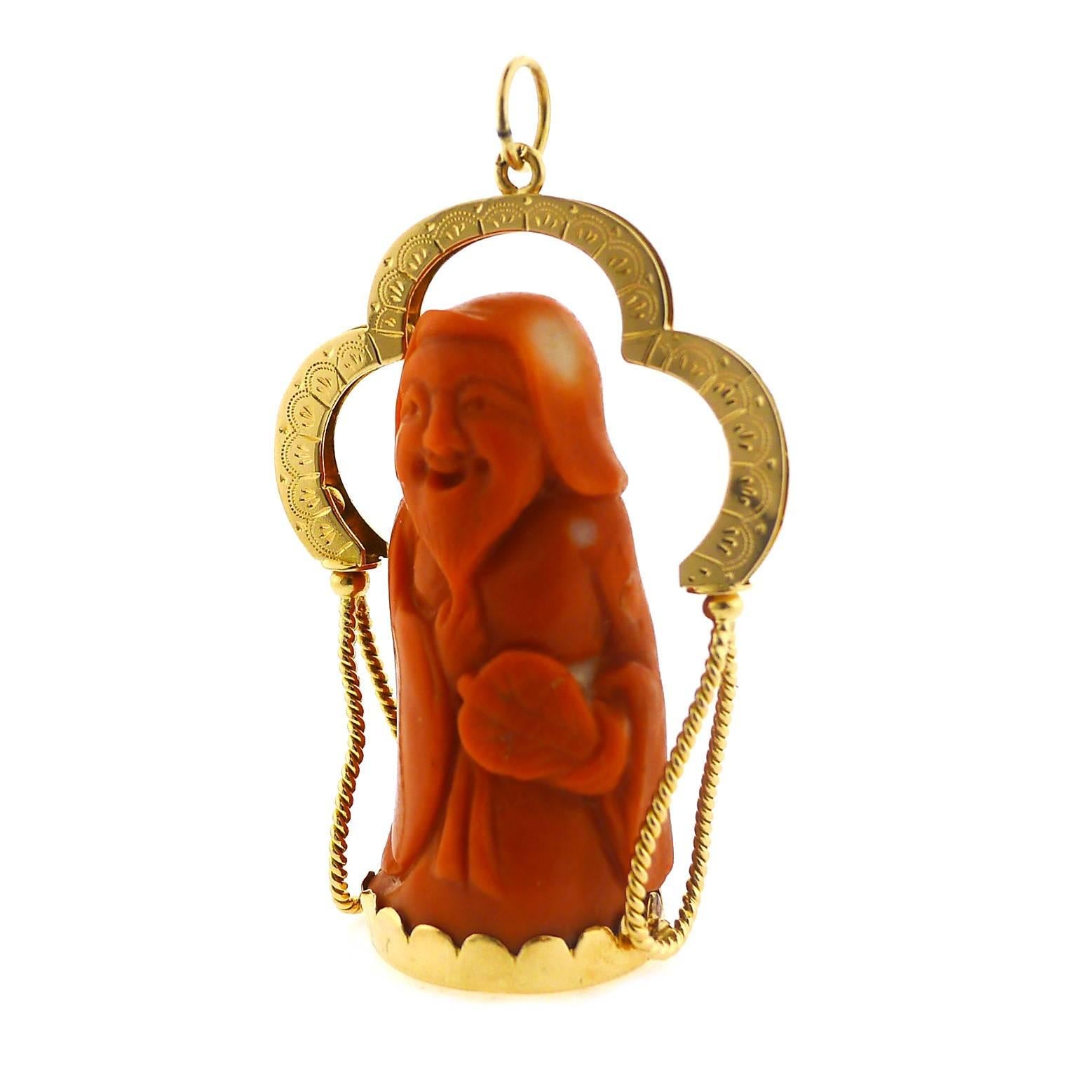 This 40 millimeter high carved coral figure sits in an 18 karat yellow gold base with a handmade and hand engraved casing. The total height is 50 millimeters.  Coral is in excellent condition.