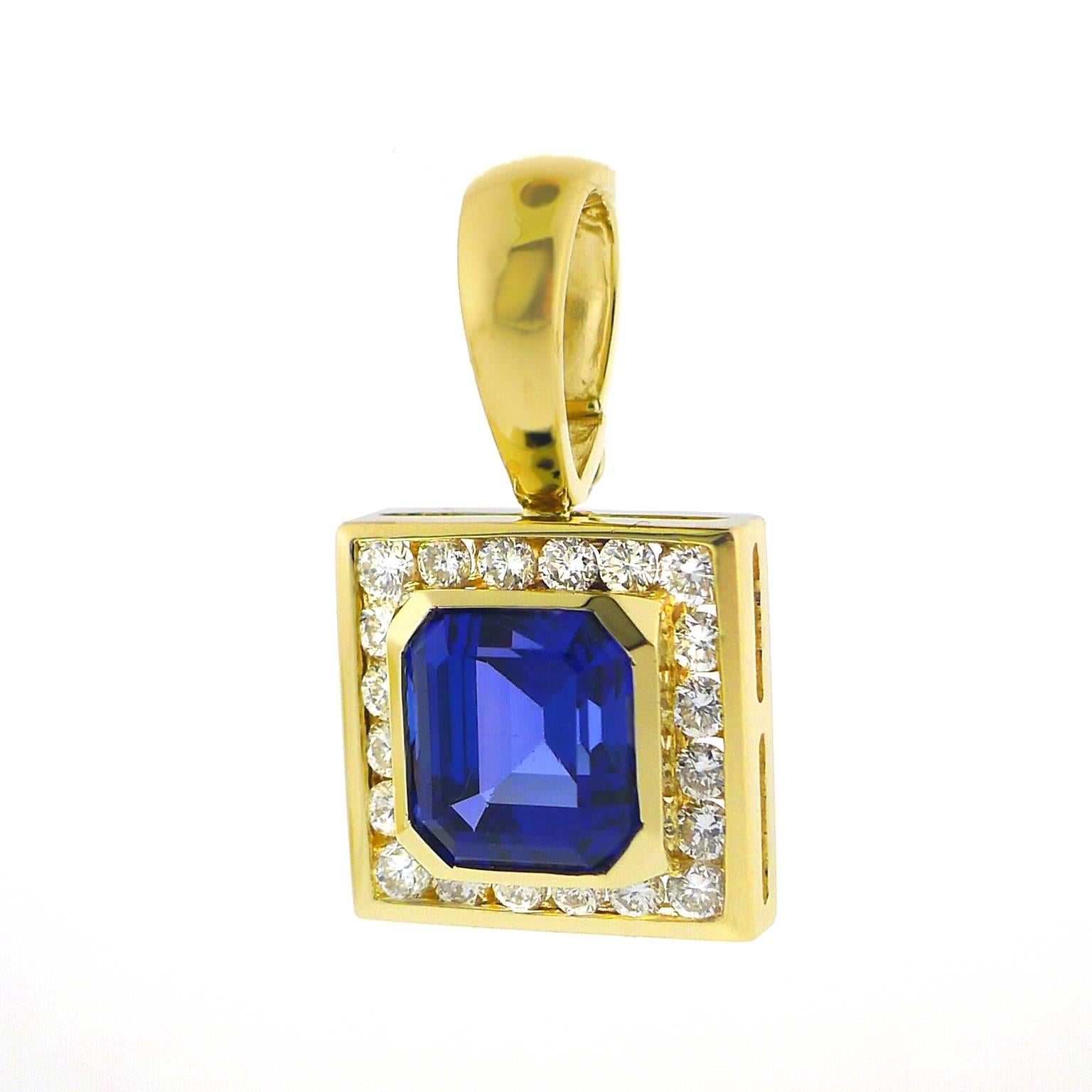 A gem-quality 8.5 millimeter by 10 millimeter rectangular tanzanite with cut corners is bezel set into 14 karat yellow gold, and surrounded by 20 channel set round brilliant cut diamonds weighing approximately five points each and totaling