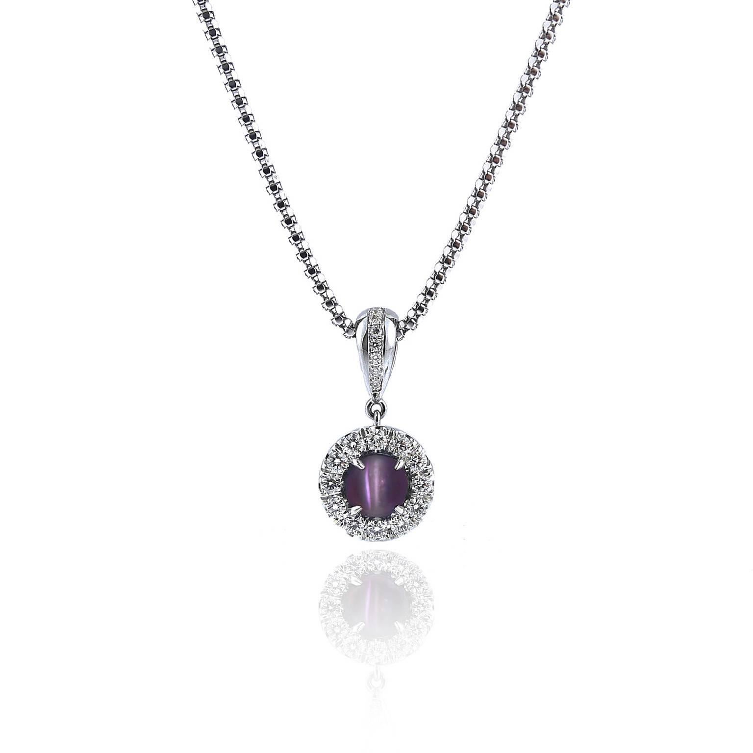 This pendant contains a 1.63 carat round cat's eye alexandrite with a fine bluish-green to purplish-red color change and strong eye. It is of Brazilian origin. There is a matching cat's eye alexandrite on our site whose stone is from the same lot as