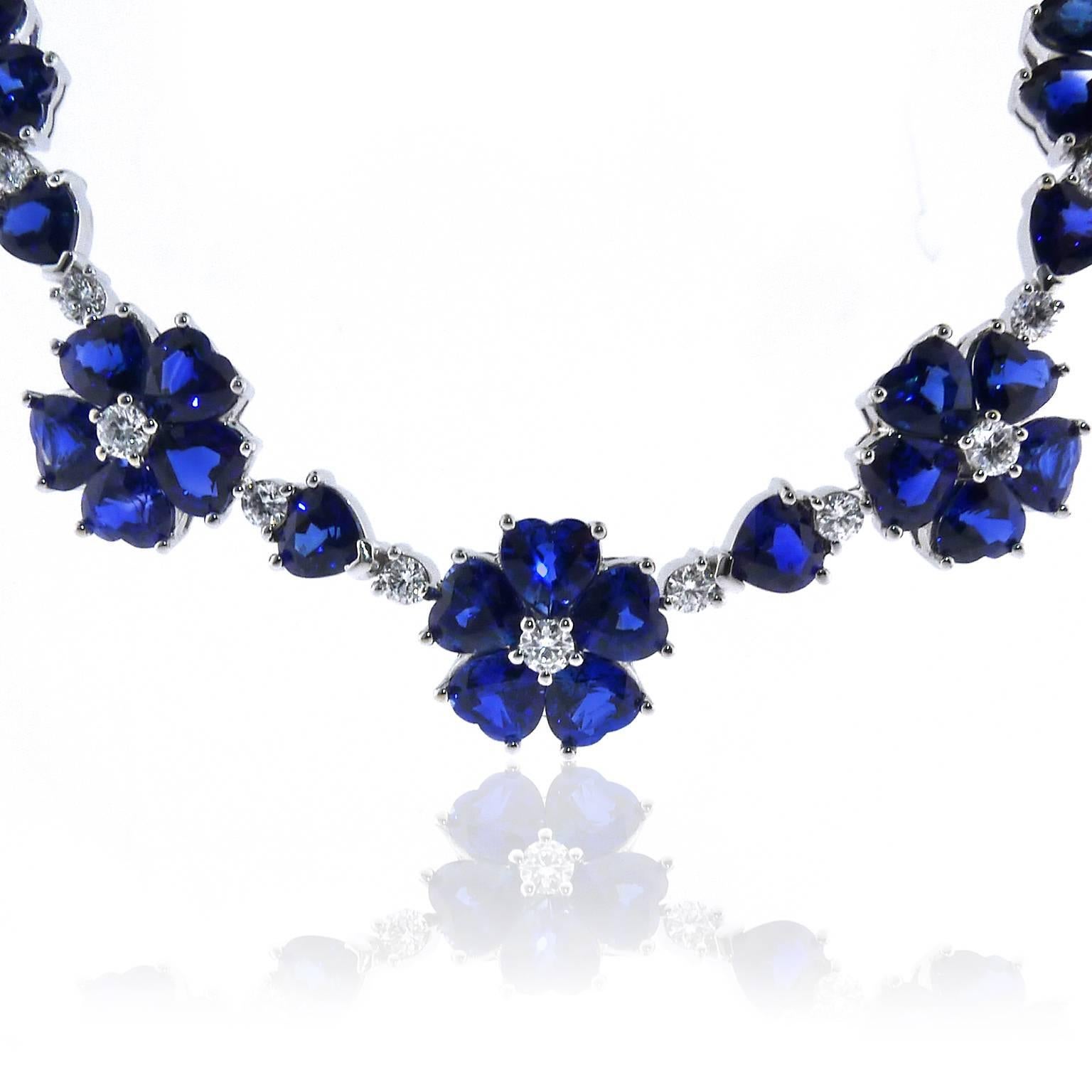 This stunning necklace boasts over 25 carats of bright blue sapphires and over 3 carats of brilliant cut diamonds. Measures 17.75 inches long and can be made longer with extra links for an additional cost. Sapphires were sourced at the prestigious