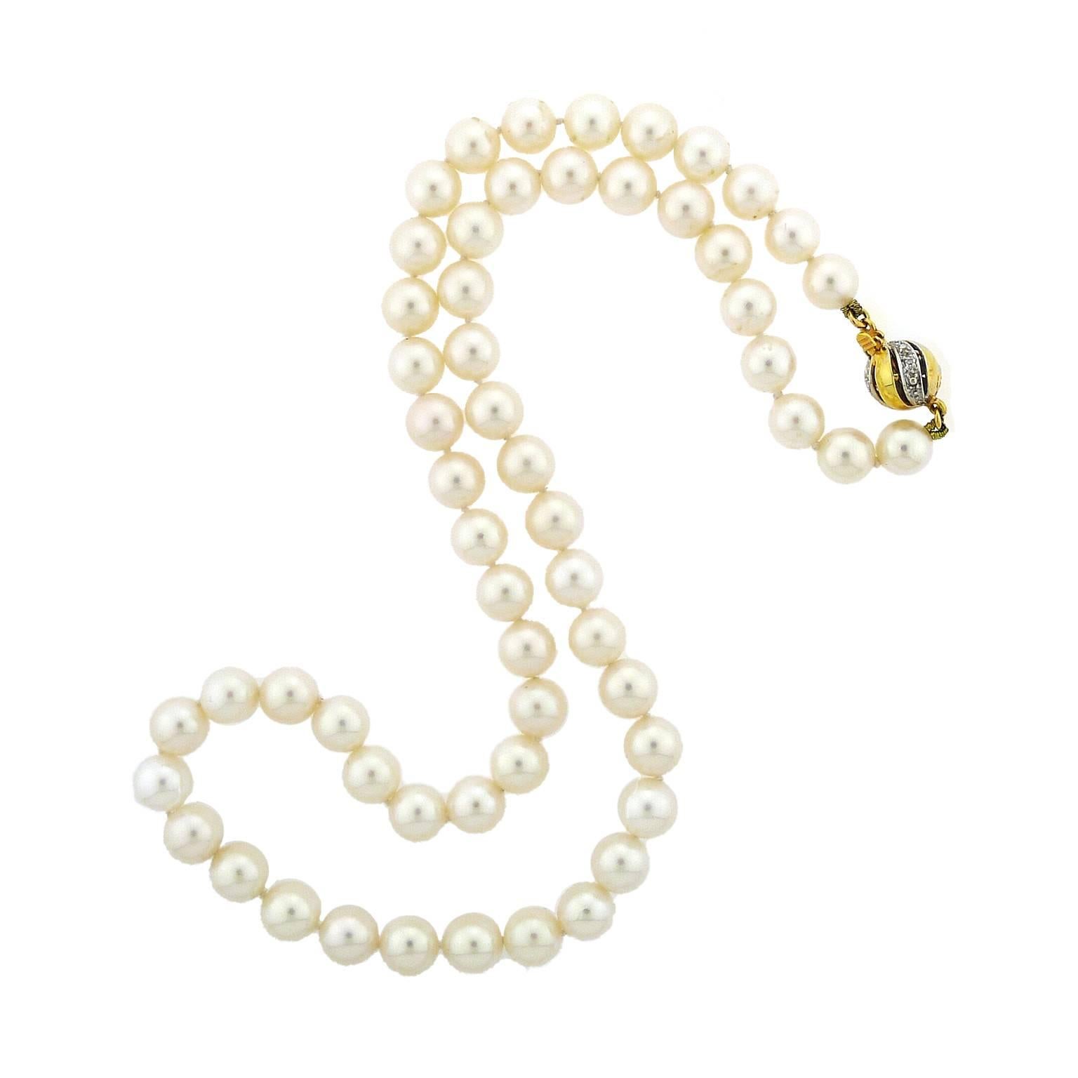 57 pearls measure from 6.93 millimeter to 7.37 millimeter. Luster is excellent, color is creamy white, there are occasional surface spots that are difficult to see.
Clasp is 14k yellow and white gold with small pave diamonds. Strand measures 17.5