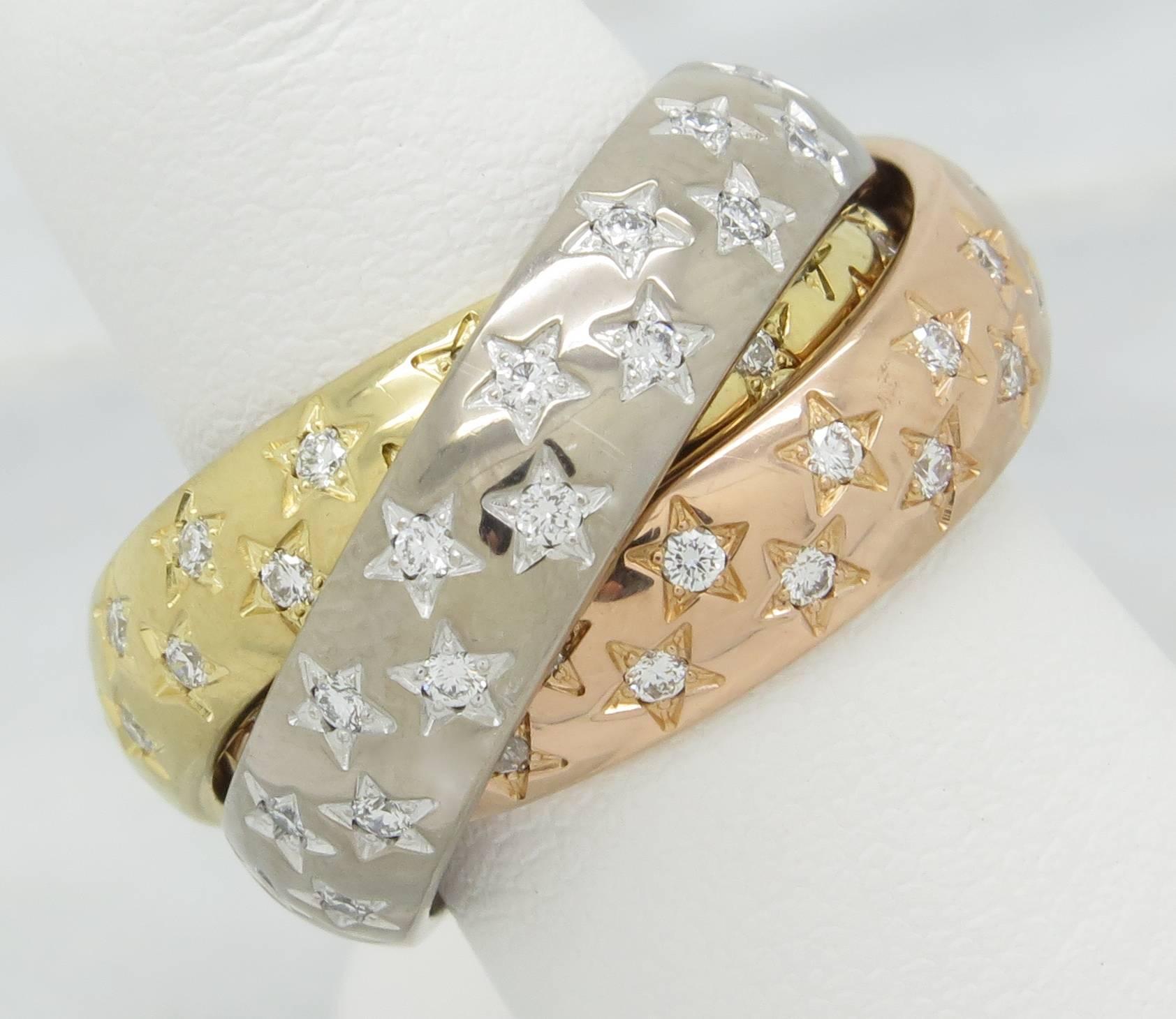 Cartier diamond Trinity ring that features three interlocked bands in 18K white, yellow and rose gold. The ring features 105 Round Brilliant Cut Diamonds. The diamonds have F-H color and VS clarity. The total diamond weight is approximately 1.05CTW.