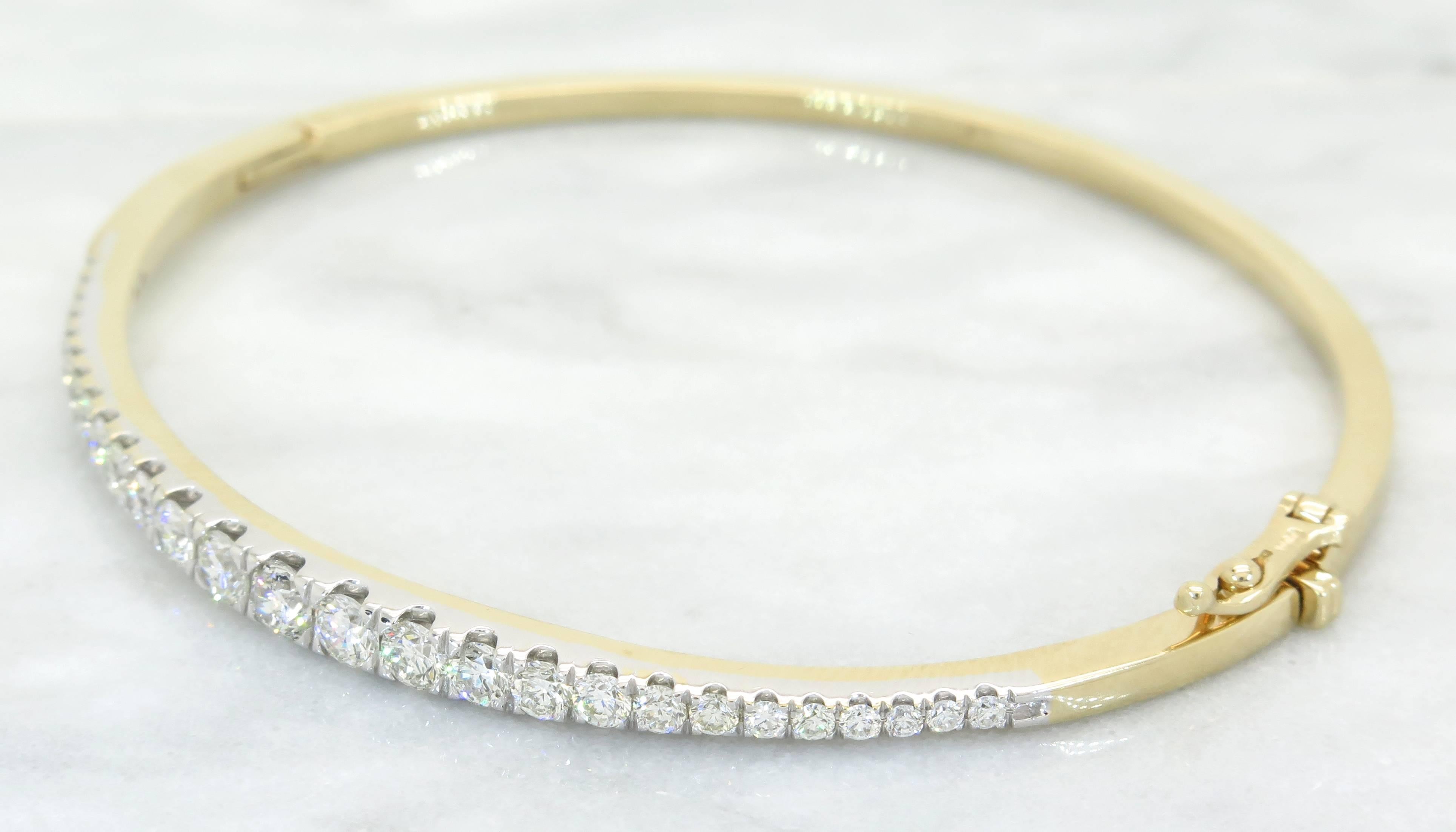 This beautiful bangle bracelet features 27 Round Brilliant Cut Diamonds. The diamonds have H-J color and I-SI clarity. The total diamond weight is approximately 1.17CTW. The 14K yellow & white gold bracelet is size 6.5