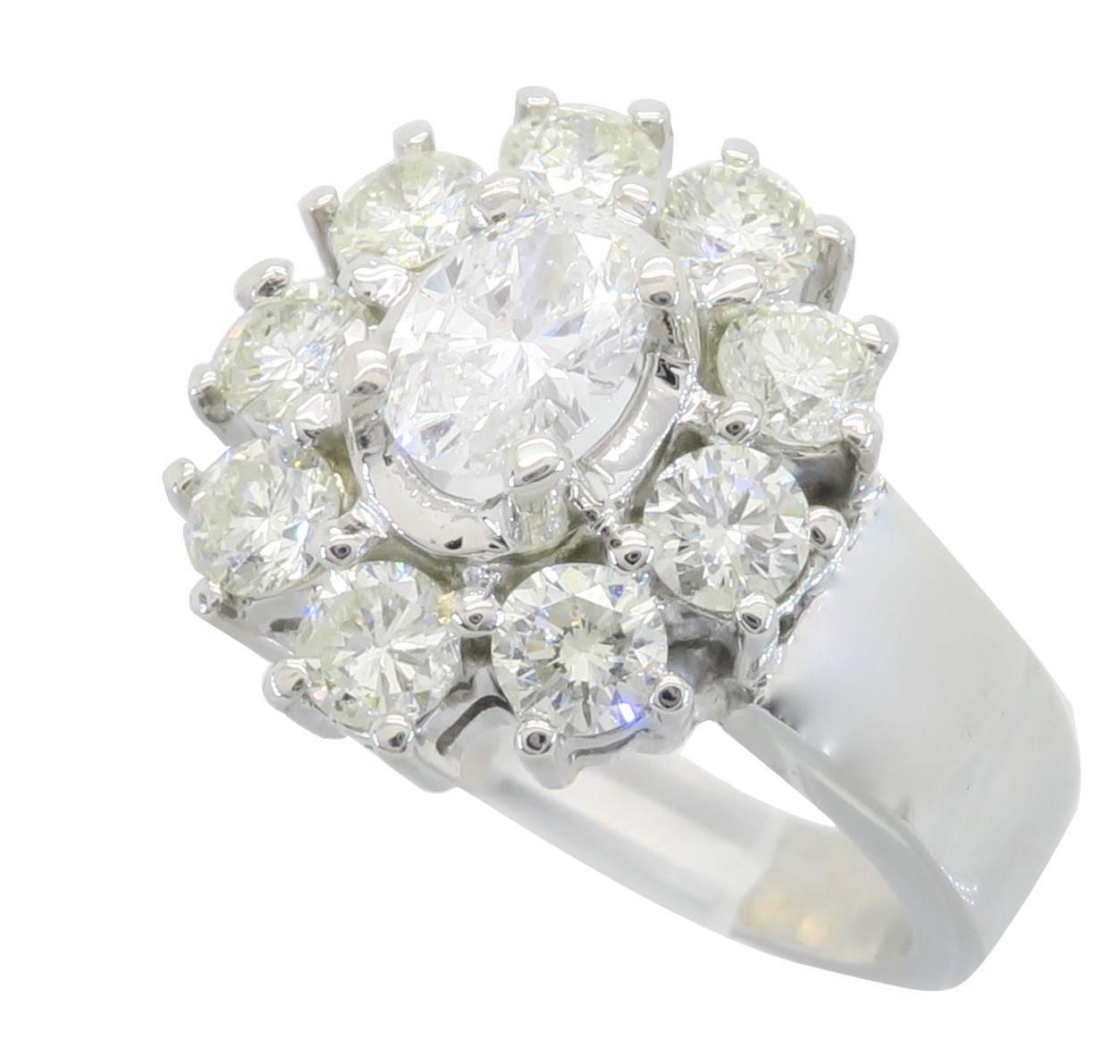 Beautiful 14K White Gold Diamond halo-style ring has an Oval Brilliant cut diamond in the center weighing approximately .34ct, the diamond has G-H color, I clarity. Surrounding this beautiful Diamond are an additional 9 Round Brilliant Cut Diamonds.