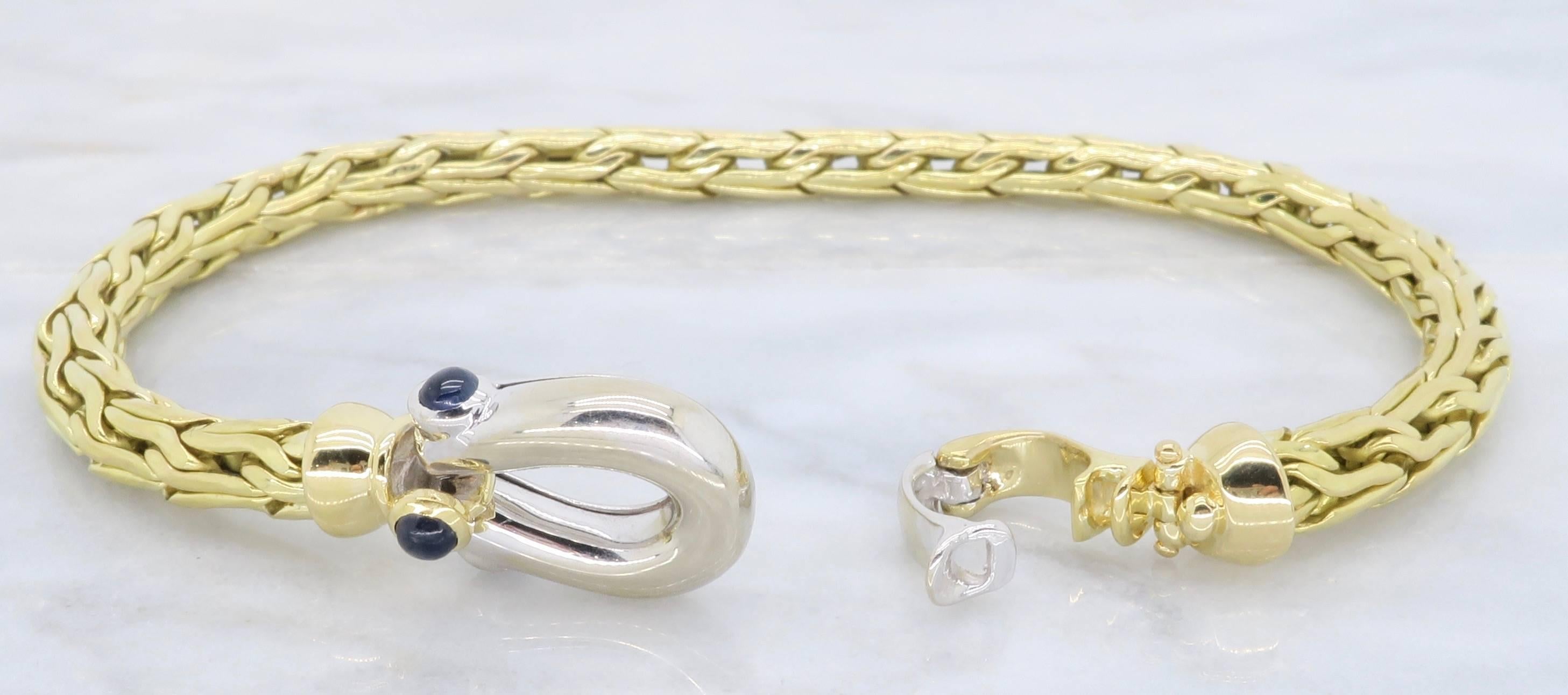 Beautiful Roberto Coin 18K Yellow Gold woven link bracelet, with a 18K White gold clasp. On the unique clasp of this designer bracelet are three round Blue Sapphires. The bracelet weighs 15.1 grams and is 6.5inches in length. The style number of