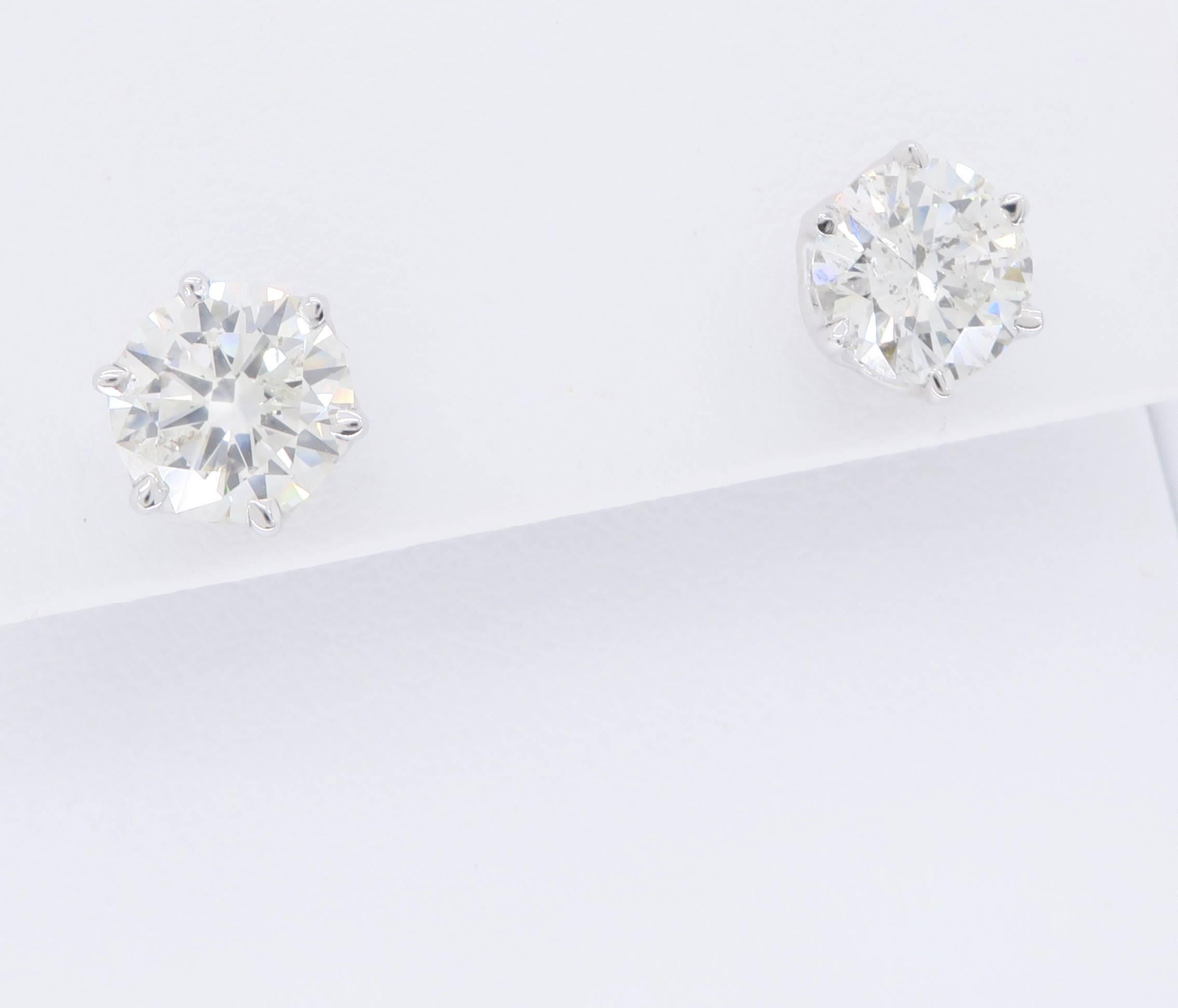 Classic Diamond stud earrings set in ornate and beautiful 14K White Gold baskets. The diamonds are 1.25CT, and 1.23CT Round Brilliant Cut Diamonds with I-J color, and I1 clarity. The studs have a total carat weight of 2.48CTW. 