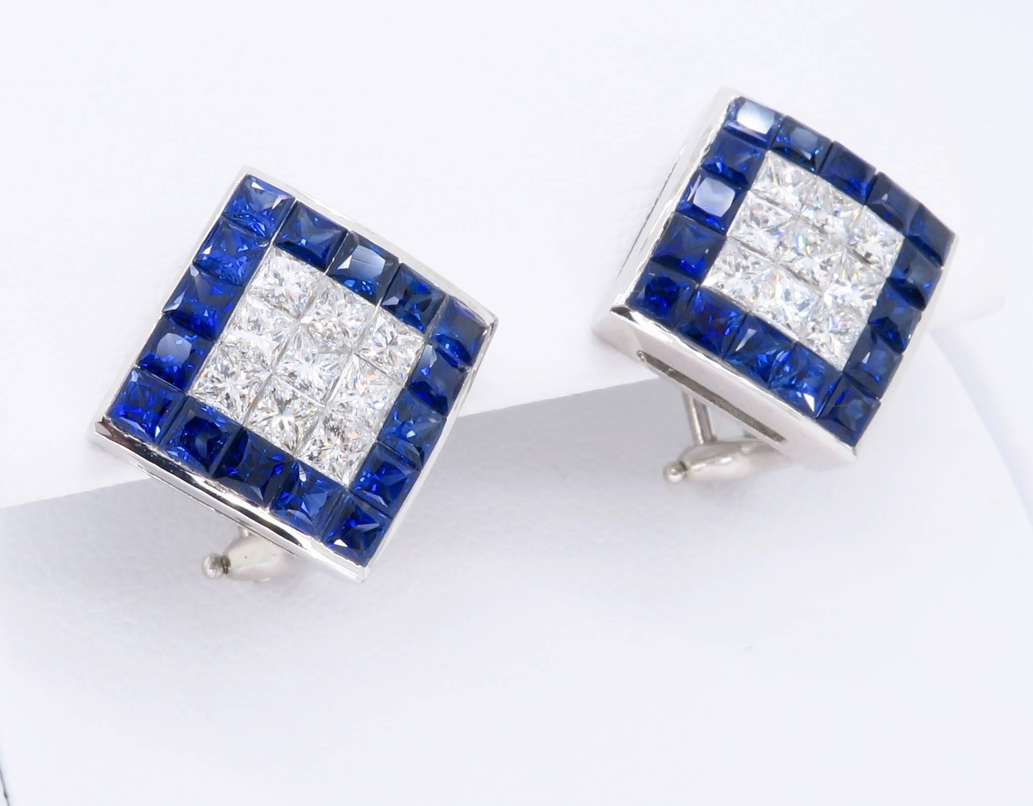 Gorgeous pair of 18K white gold diamond and sapphire earrings.  Each stunning earring houses 9 beautiful Princess Cut Diamonds and 16 blue lab created sapphires. The vivid blue sapphires surround approximately 1.44CTW of diamonds. The diamonds