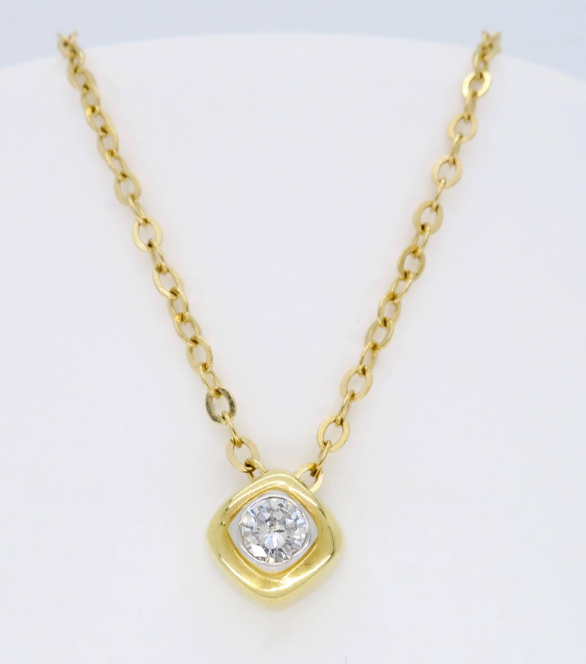 14K yellow gold necklace features an .18CT Round Brilliant Cut Diamond. The beautiful diamond is bezel set in a petite soft cornered diamond shaped pendant.  The featured diamond displays J-K color and SI2 clarity. The necklace is 18” long and