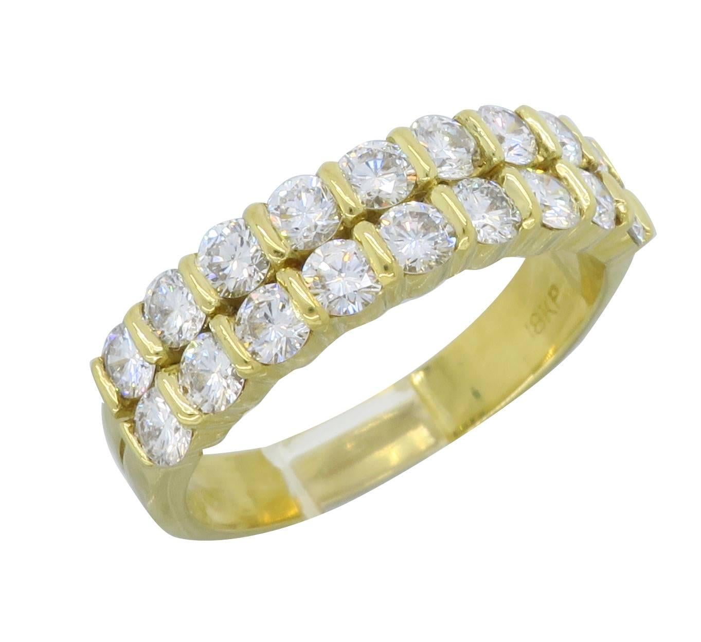 18k Yellow Gold diamond band with 18 Round Brilliant cut diamonds, bar set, with an approximate total carat weight of 1.26ctw. The diamonds display an average color of H-I and average clarity of VS. The ring is currently a size 6.75 and weighs 5.0