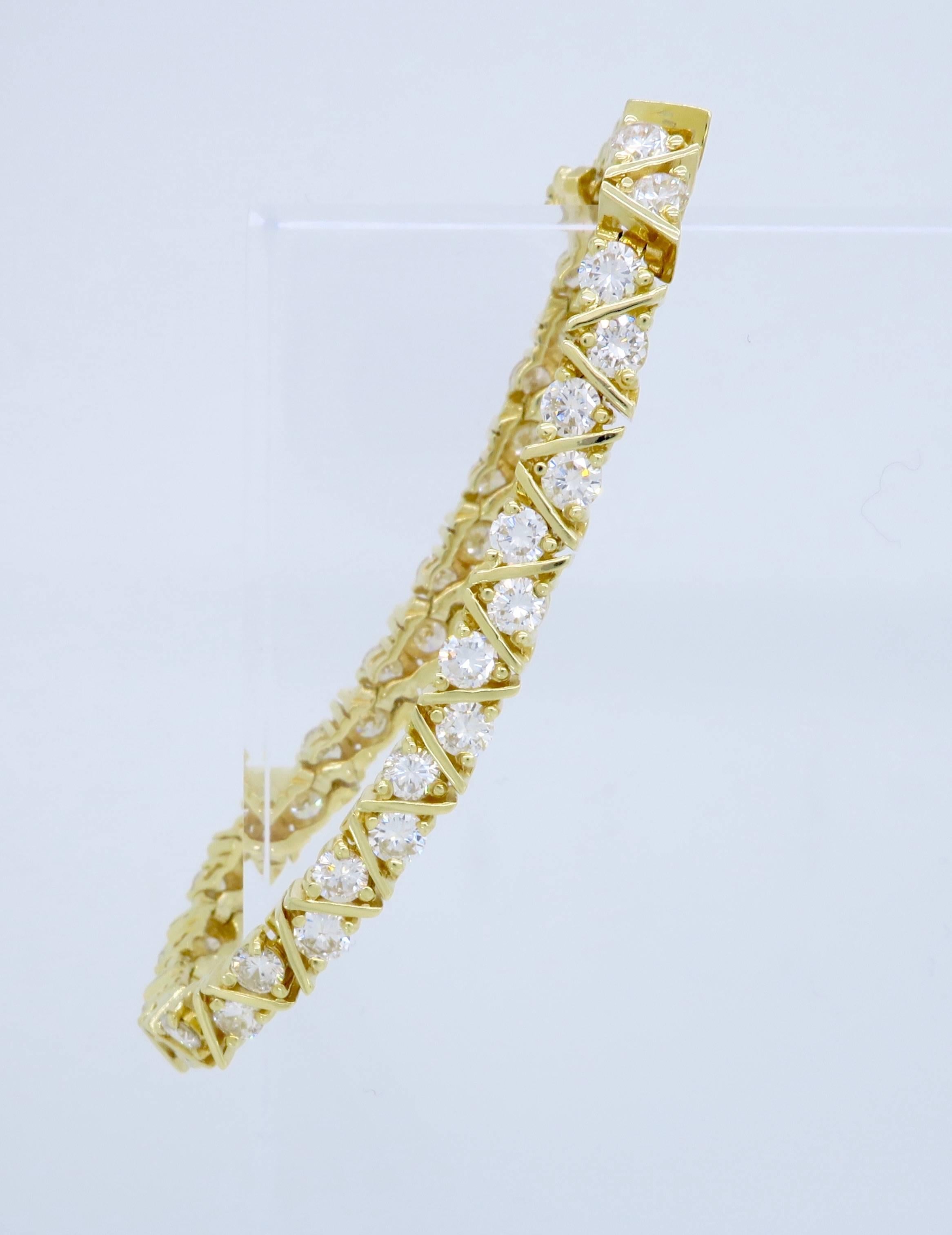 Unique diamond bracelet with 44 Round Brilliant Cut Diamonds with a total carat weight of approximately 6.16ctw. The diamonds display an average of G-H color and an average of SI1-SI2 clarity. The 14K yellow gold line bracelet weighs 15.2 grams and