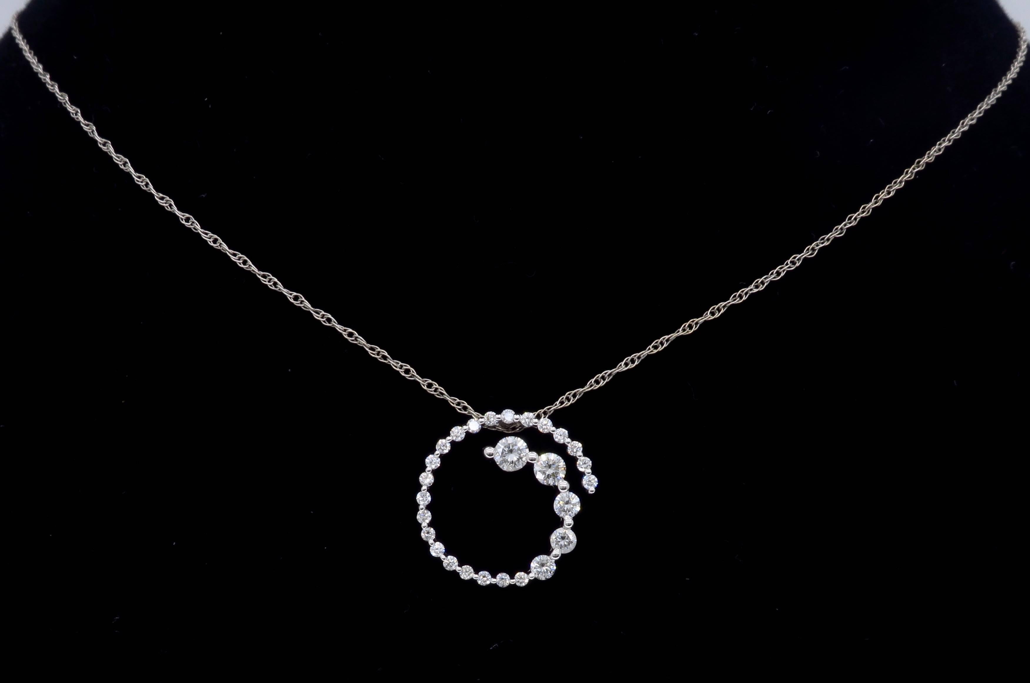 This petite swirl necklace features a 14K White Gold Diamond spiral design pendant. There are 27 Round Brilliant Cut Diamonds in the beautiful pendant. The Diamonds display VS-SI clarity and G-H color. This stunning pendant houses approximately