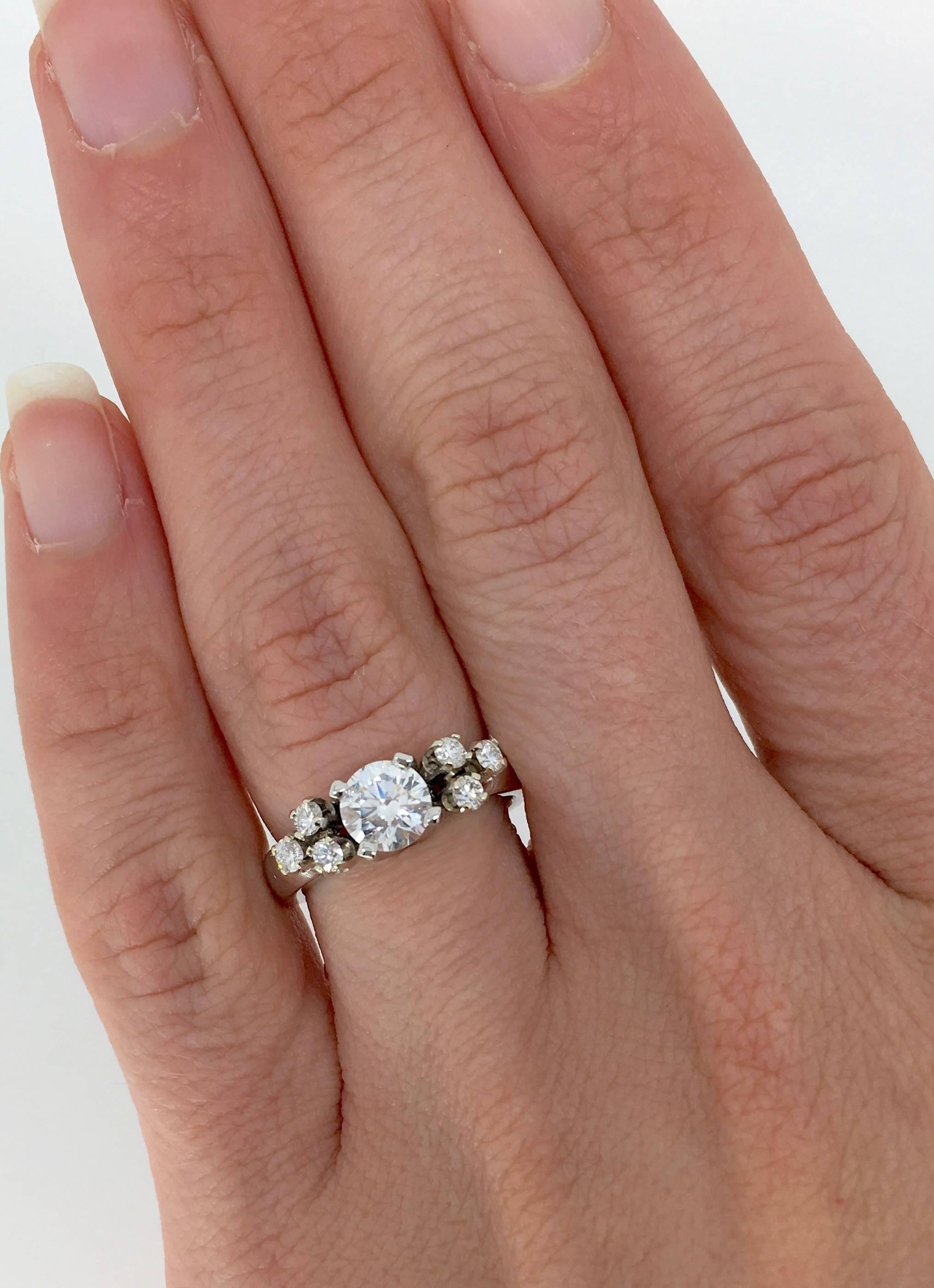 This gorgeous ring features a GIA certified .75CT Round Brilliant Cut Diamond in the center with D color, VS2 clarity. The featured diamond is laser scribed with the GIA certification # 13205201. There are 6 additional Round Brilliant Cut Diamonds