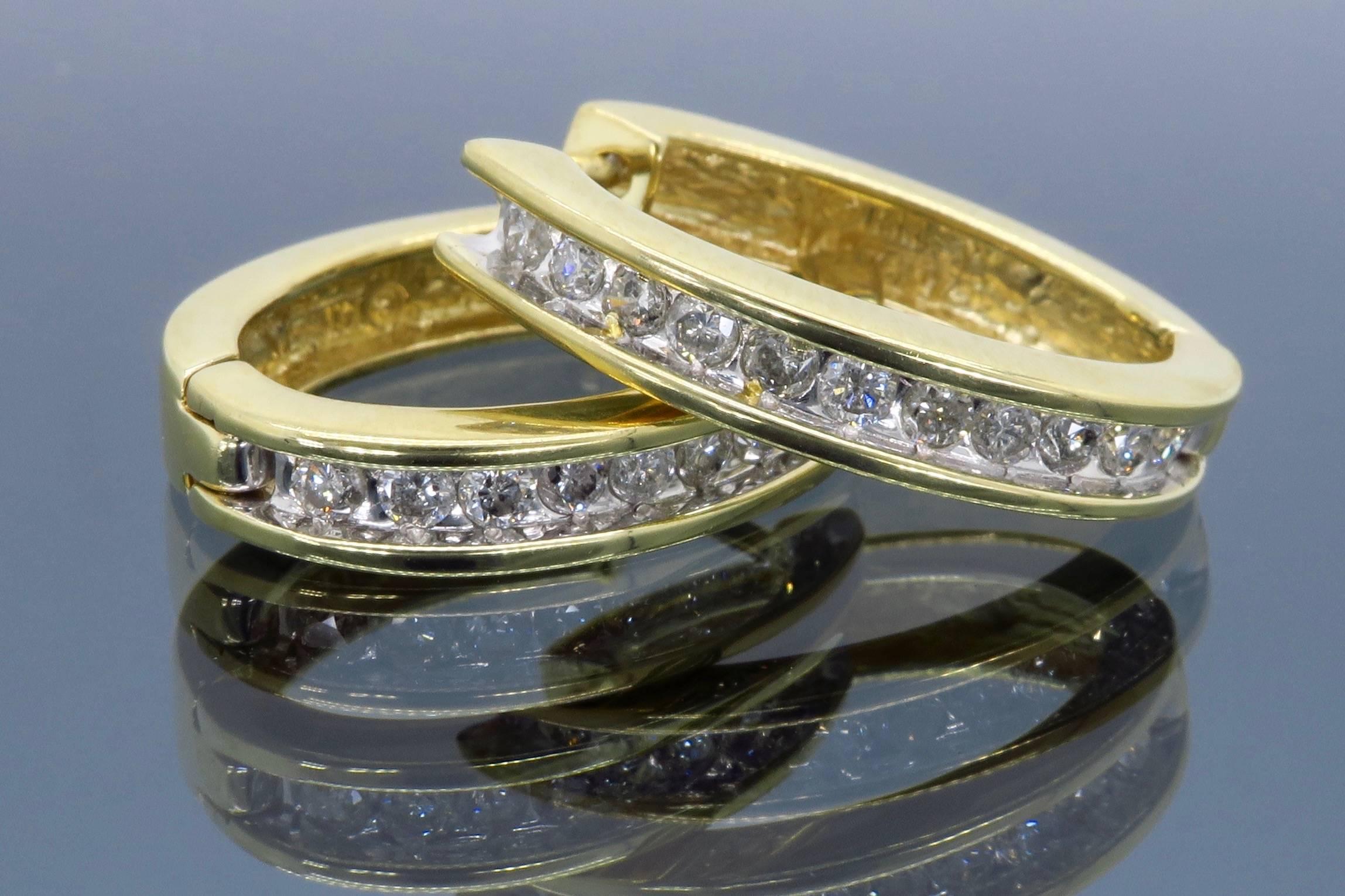 Beautiful pair of hinged back diamond hoops feature 22 Round Brilliant Cut Diamonds with an approximate total weight of .50ctw. The 14K Yellow gold earrings weigh 5.5 grams.