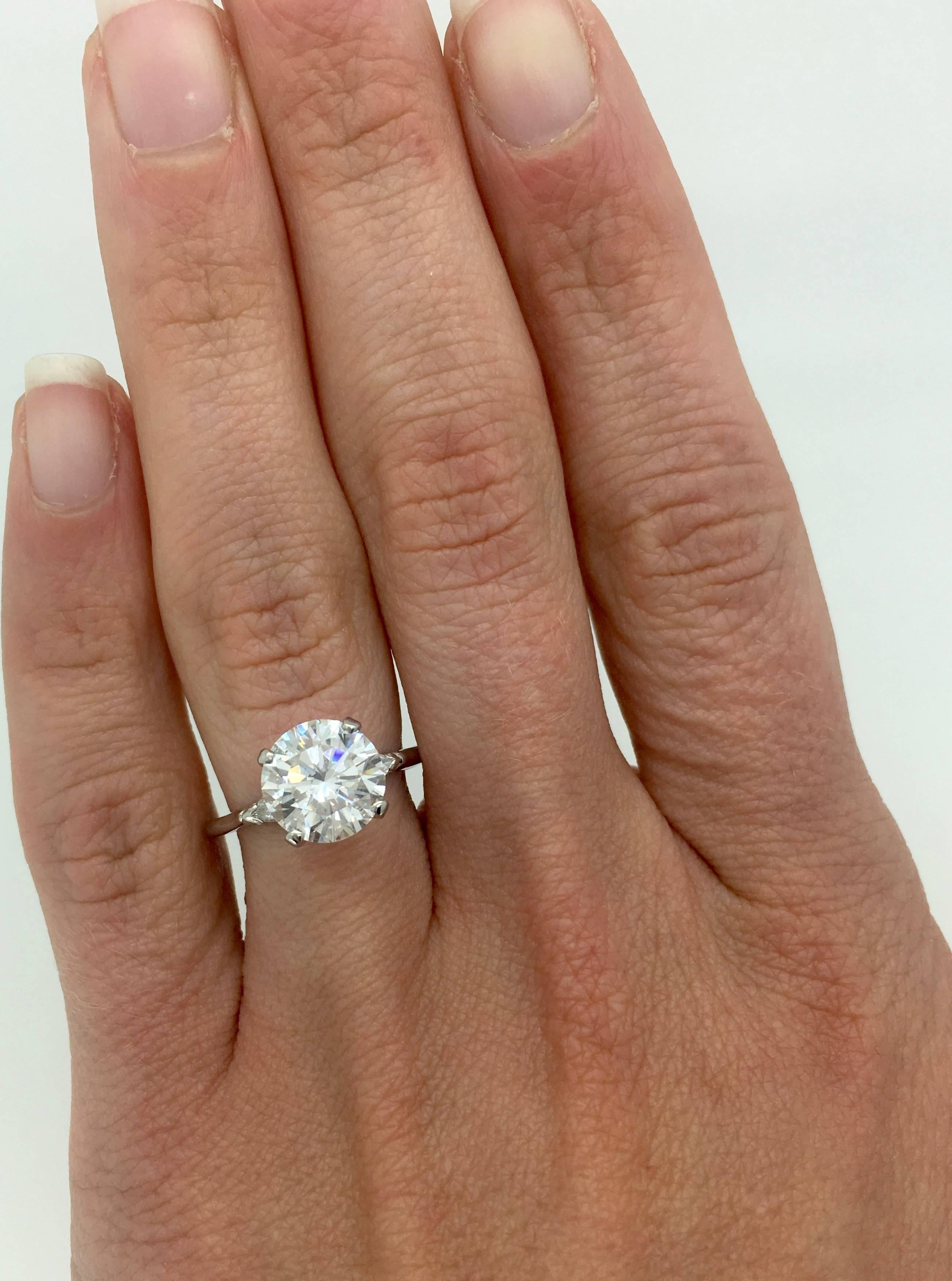 This platinum engagement ring features a 2.43CT Round Brilliant Cut Diamond displaying J-K color and SI1 clarity. Two Pear Cut Diamonds accent the featured diamond. There is approximately 2.67CTW of diamonds in this ring. Currently the beautiful