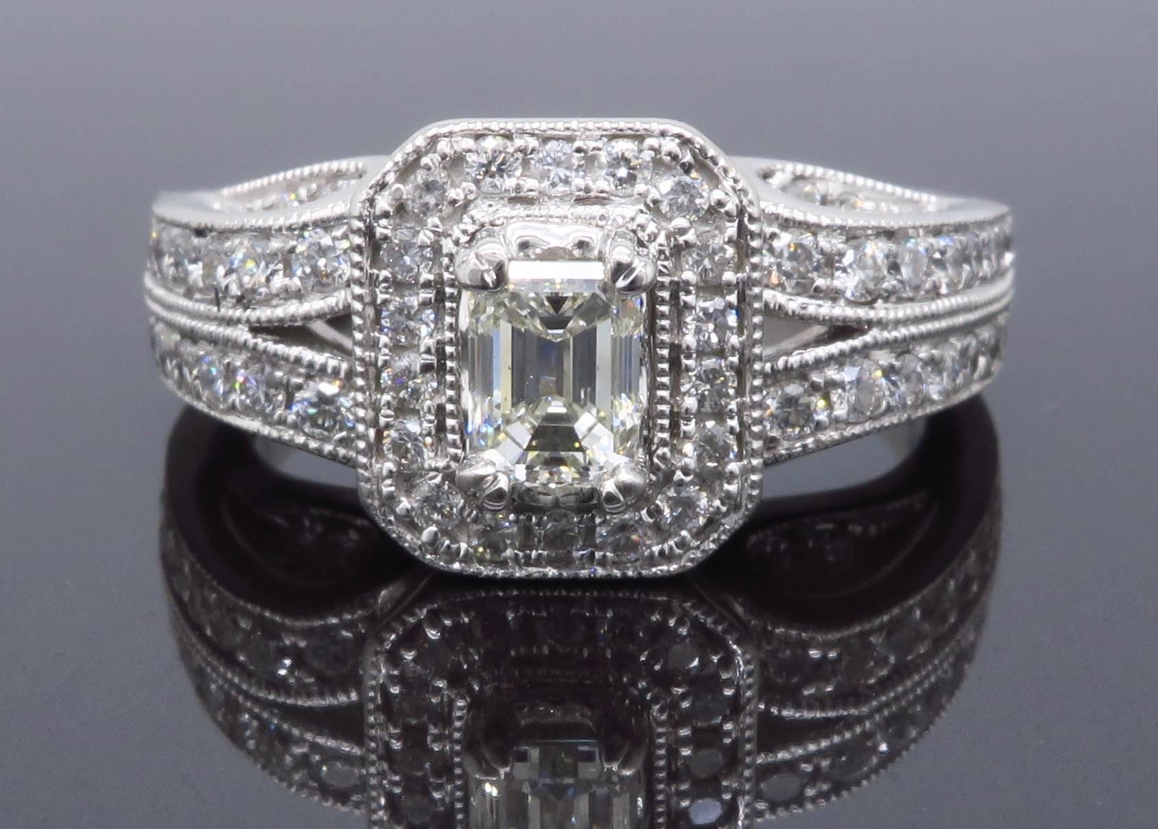 Beautiful ring featuring an IGI Certified .40CT Emerald Cut Diamond with SI1-SI2 Clarity and H-I Color.  There are 70 additional Round Brilliant Cut Diamonds that adorn the 14K white gold ring. The total approximate carat weight is 1.00CTW.