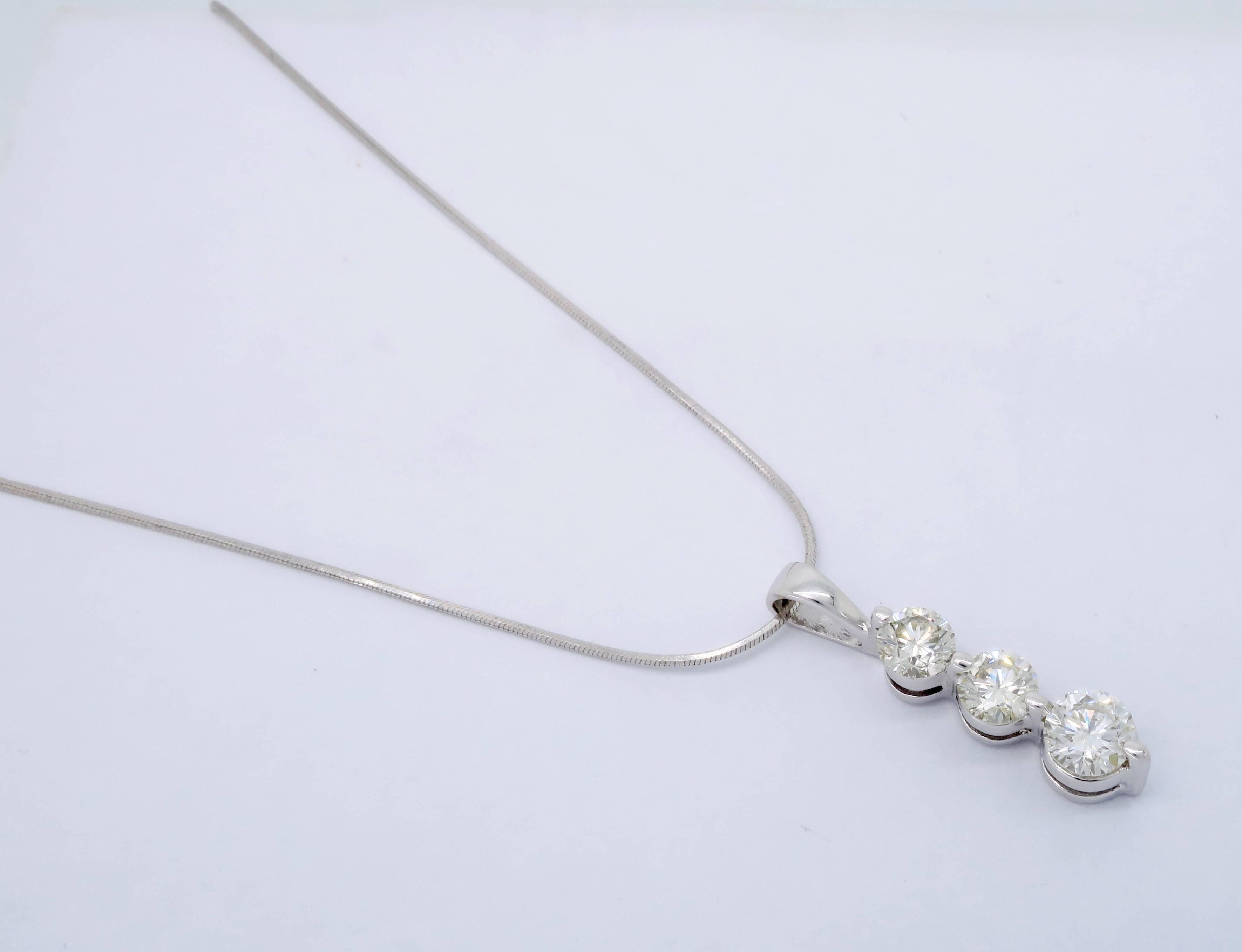 This three stone Diamond necklace features 3 Round Brilliant Cut Diamonds displaying I-K color and SI clarity. There is approximately 1.00CTW of diamonds in this 14K white gold necklace. The necklace is 16.5” in length and weighs 3.4 grams.