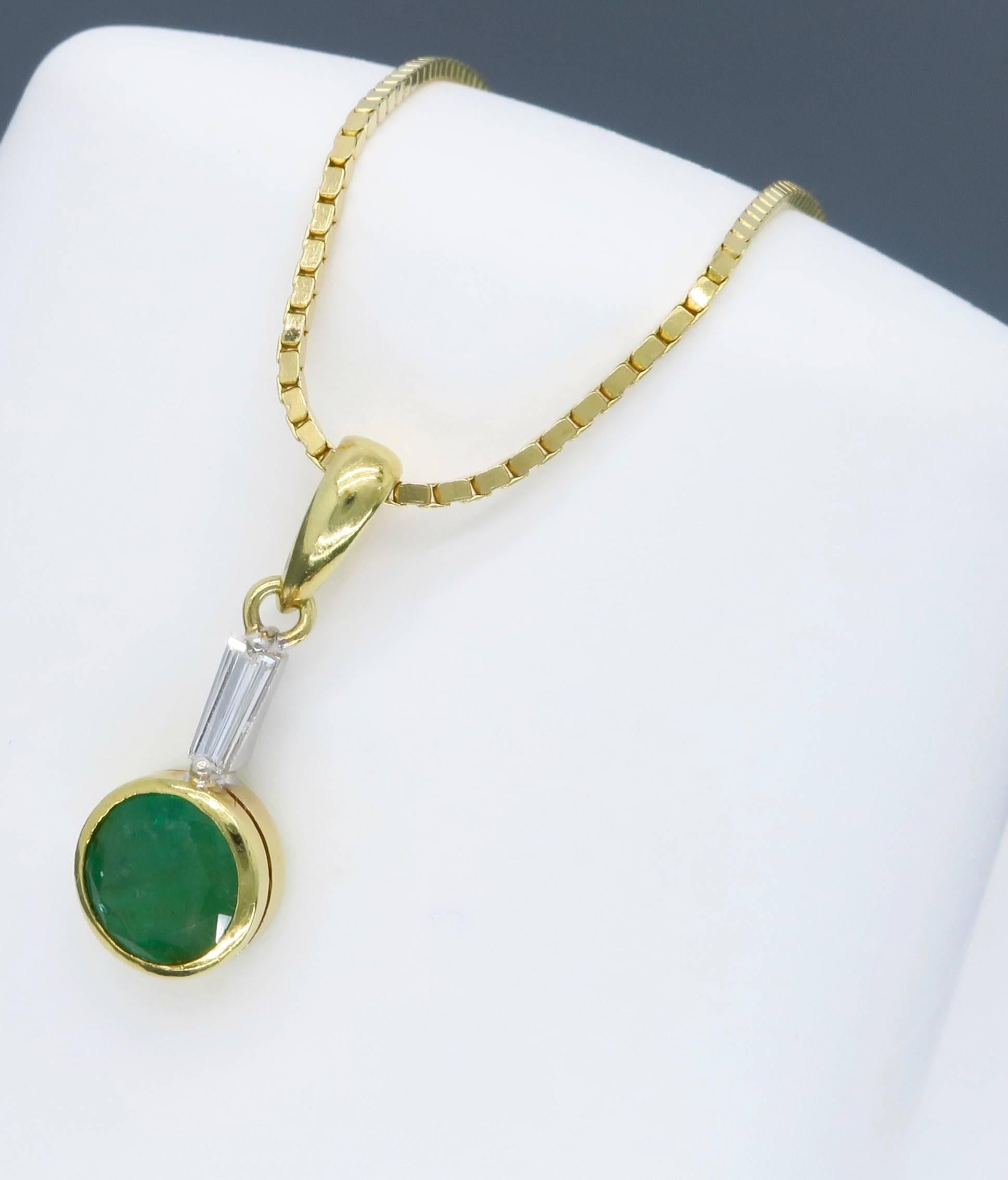 This necklace features a 6.75mm Round Cut Emerald, which is accented by a Tapered Baguette Cut Diamond weighing approximately .10CT. The 14K yellow gold necklace is 16” in length and weighs 5.4 grams.