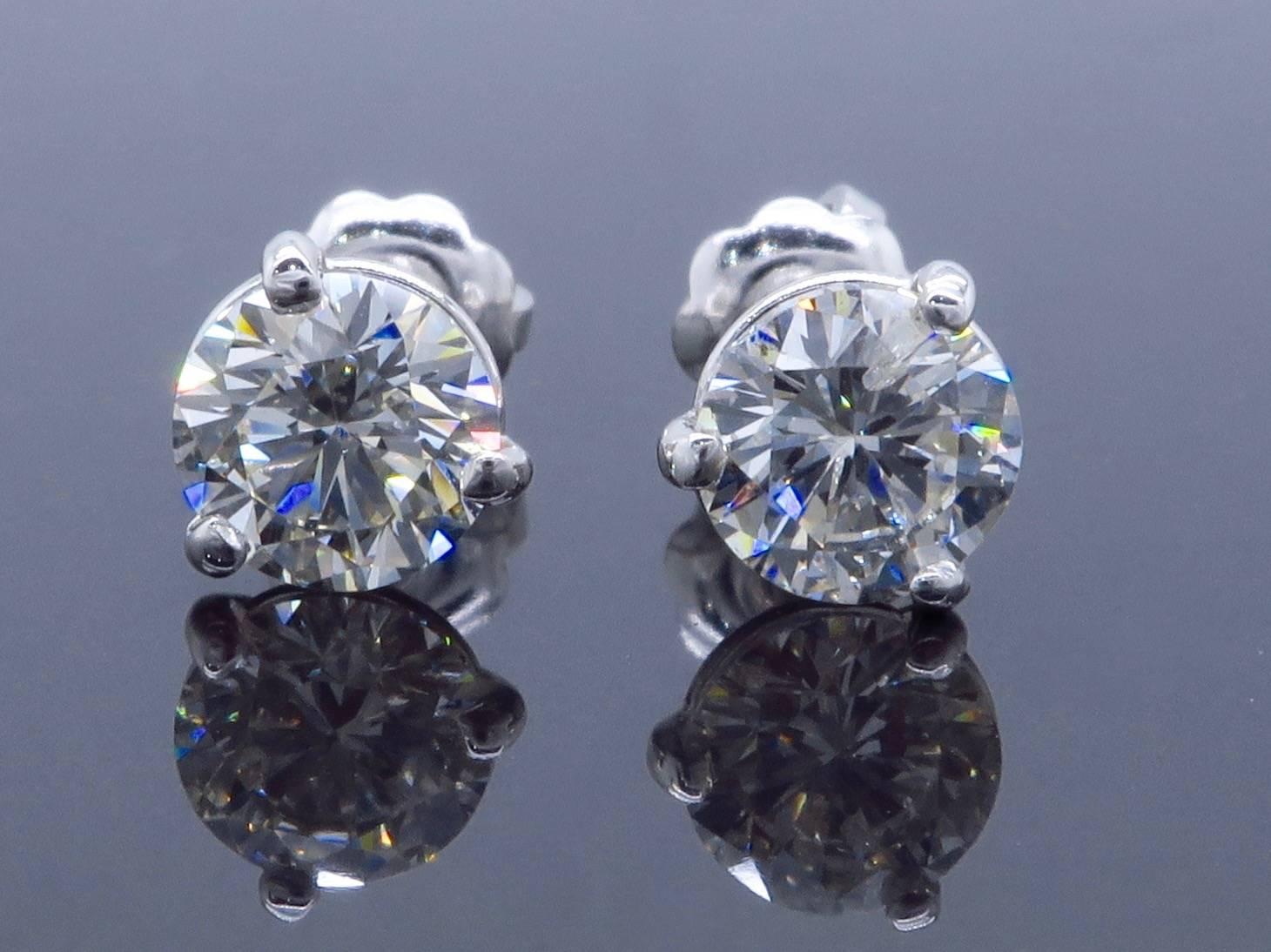 Classic pair of Martini style studs features a .54CT and .53CT Round Brilliant Cut Diamond. The diamonds display I-J color and SI-I clarity. There is approximately 1.07CTW of diamonds in this beautiful pair. The 14K white gold earrings weigh 1.00